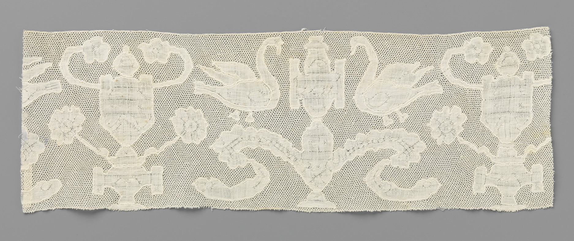 Lace work featuring a vase between two swans by Unknown Artist