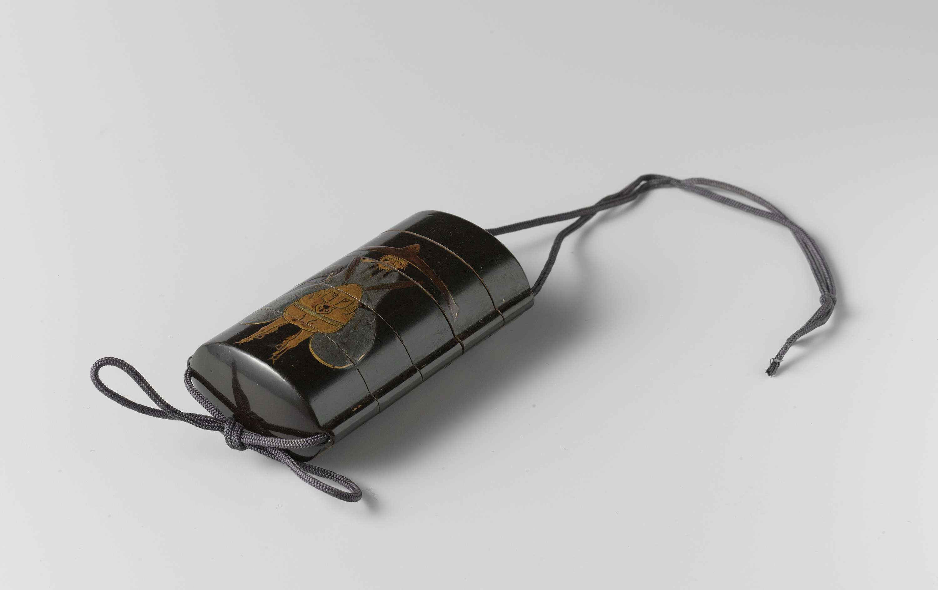 Inro made of wood featuring intricate lacquer work by an unknown artist