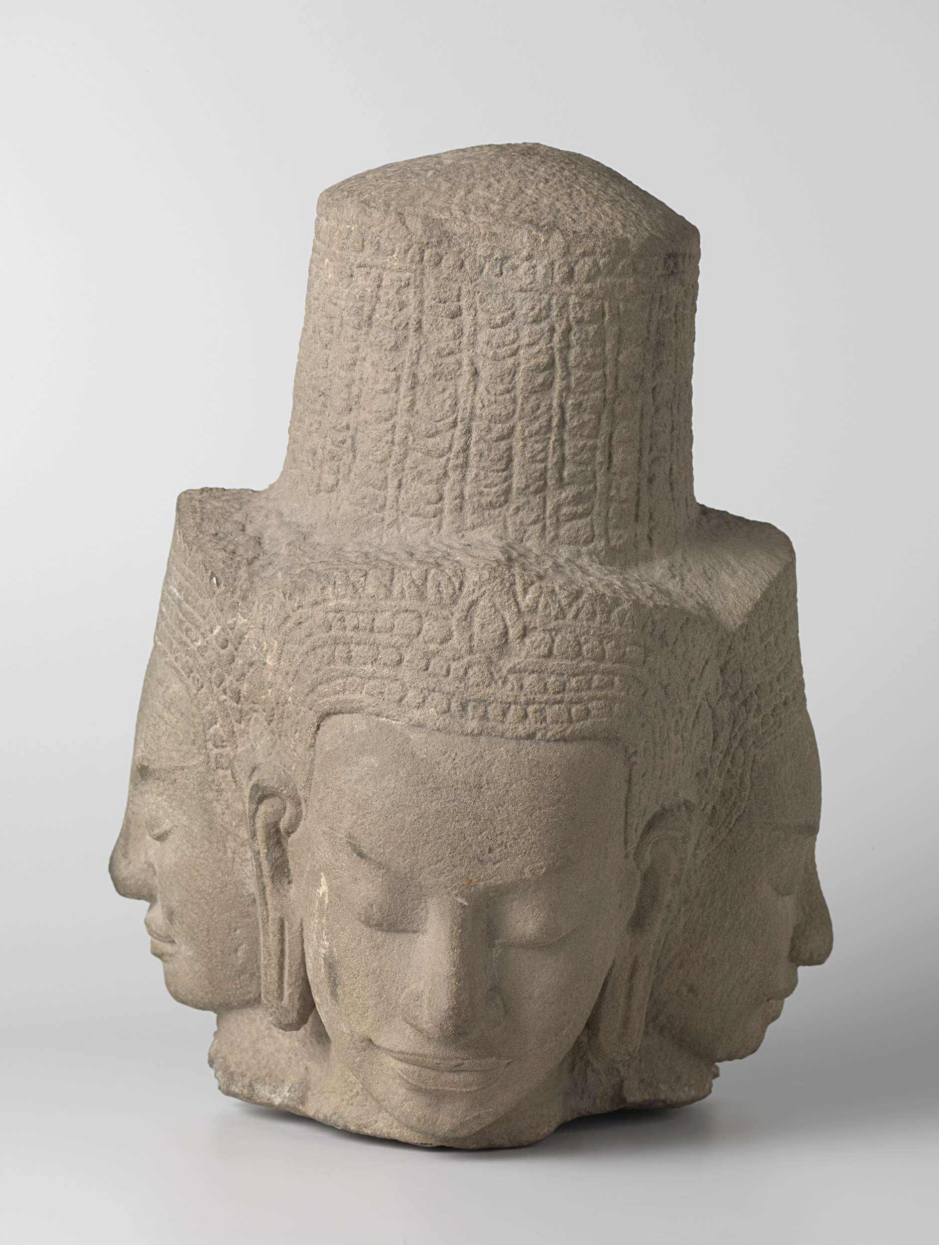 Head of a four-faced deity, stone sculpture by unknown artist
