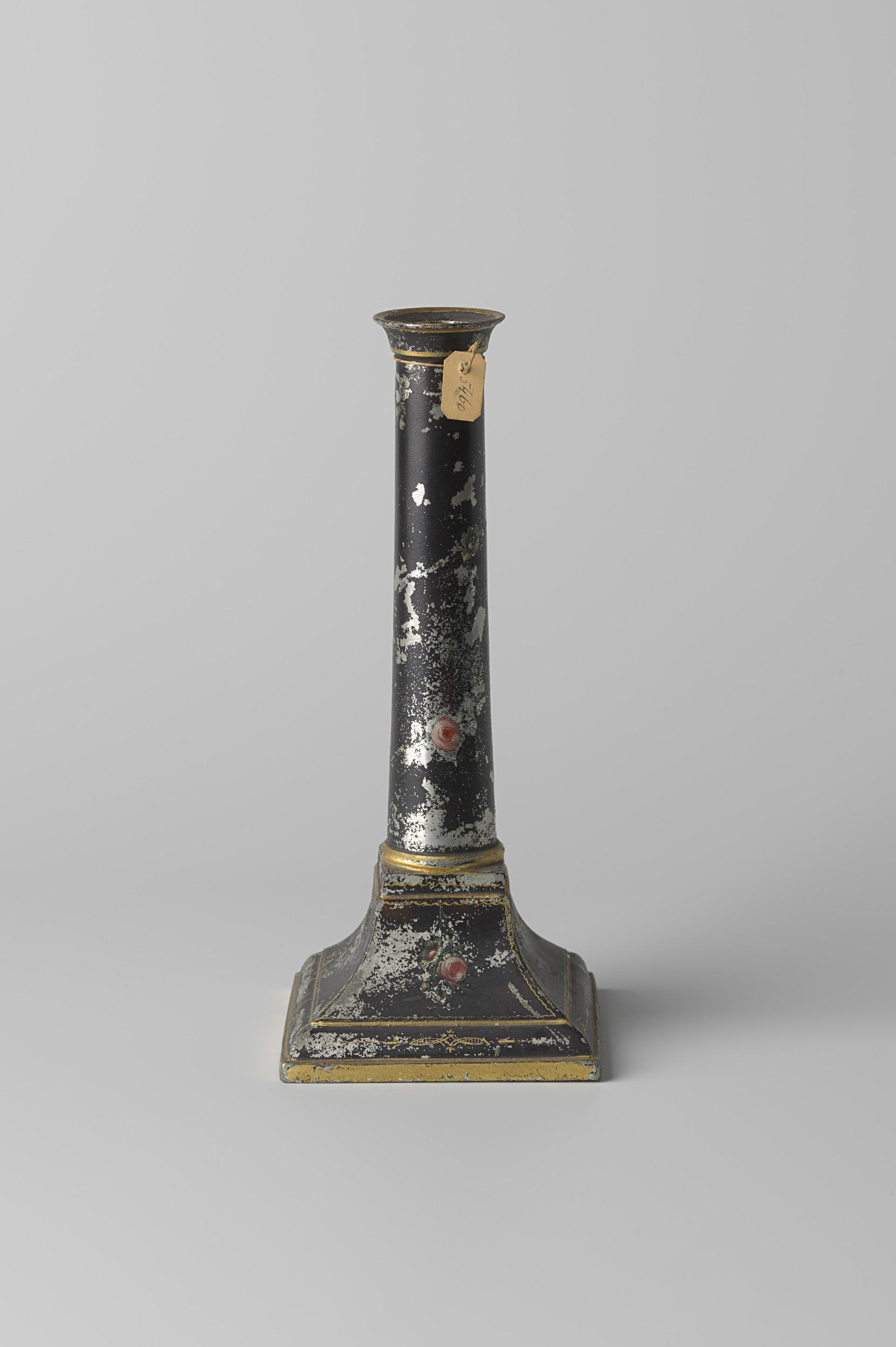 Rococo still life featuring a black candlestick adorned with flowers by Carel Lodewijk Schurffius