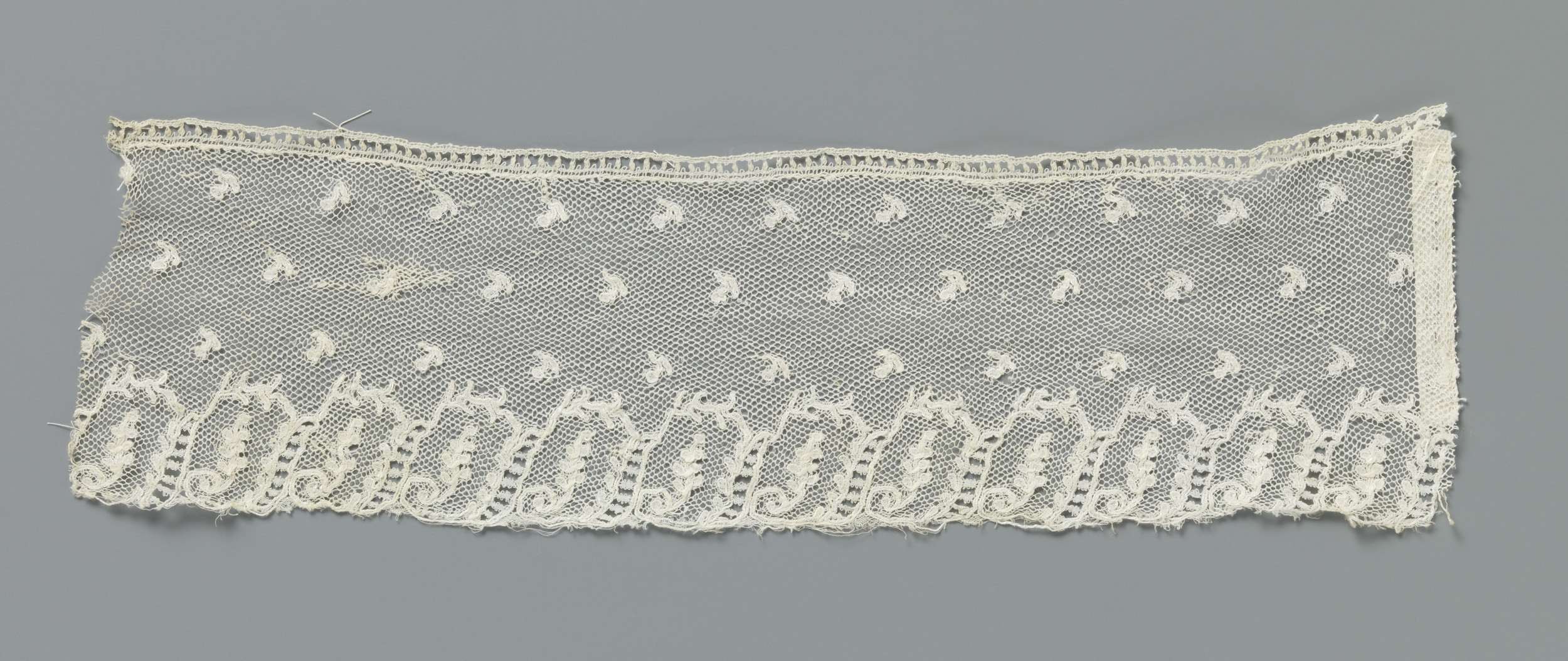 Abstract lace work by unknown artist, featuring interconnected geometric shapes.