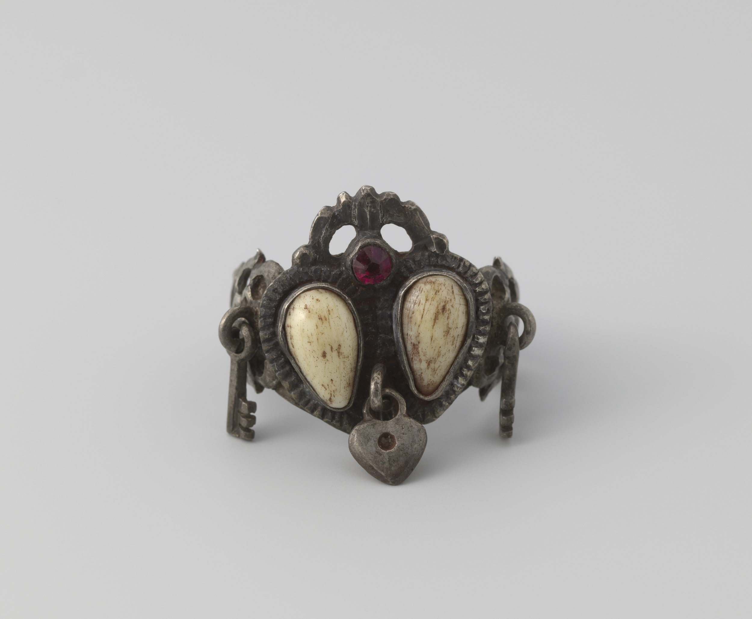 Decorative metal ring by Unknown Artist, showcasing intricate silver design.