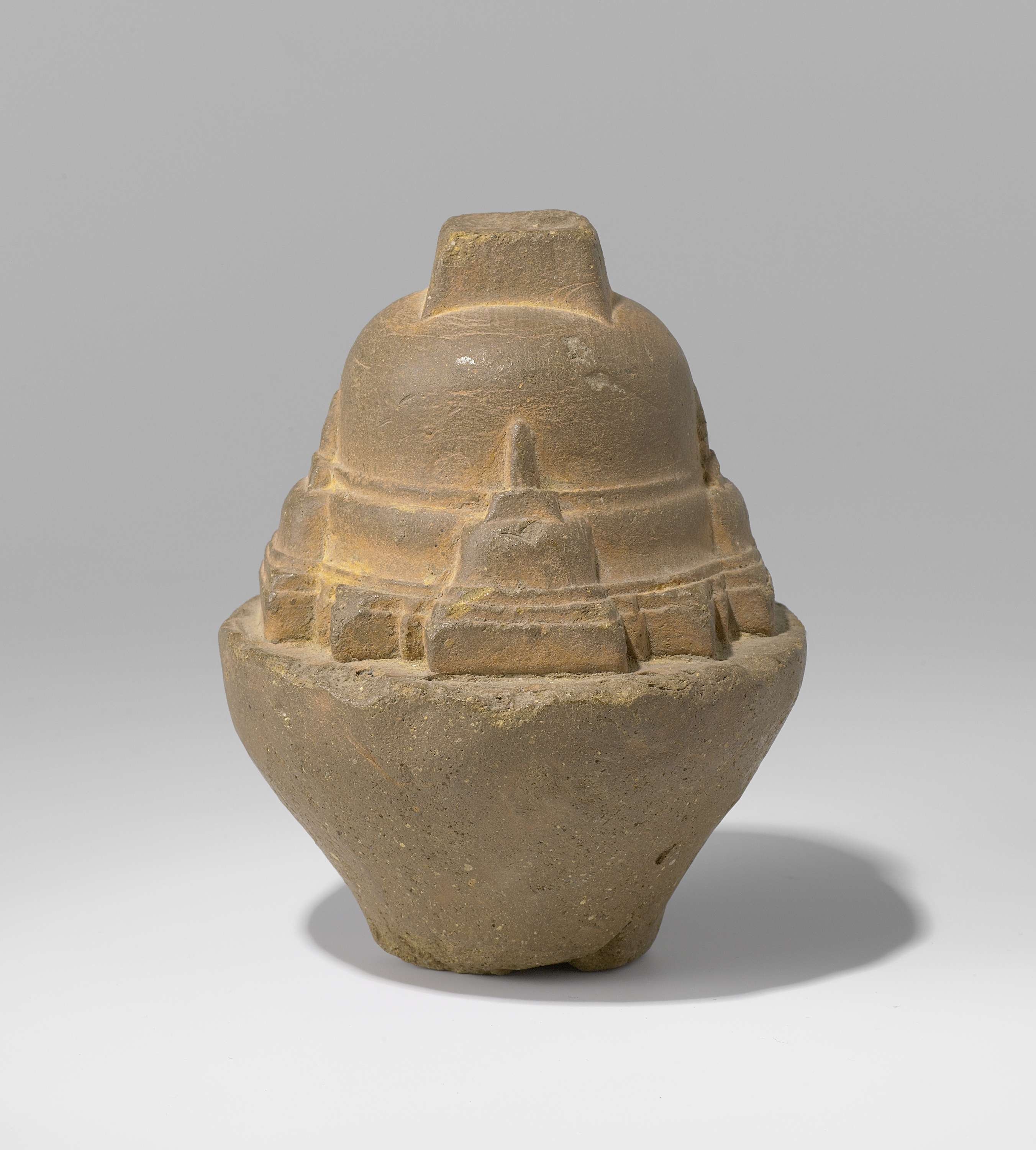 Terracotta stupa by unknown artist, showcasing intricate details and ancient design.