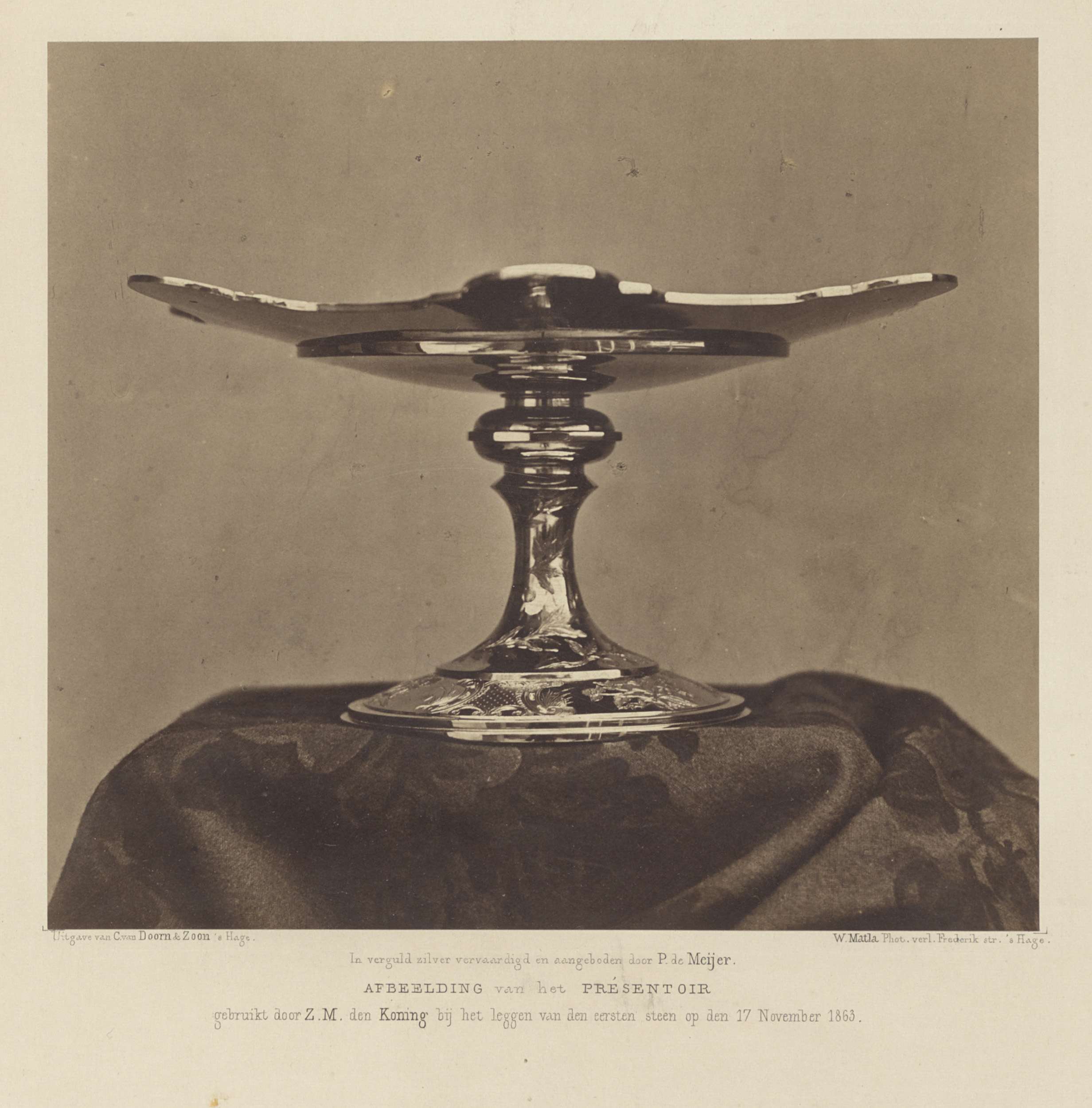 Historical albumen print by Willem Matla depicting a presentation stand with elegant drapery.