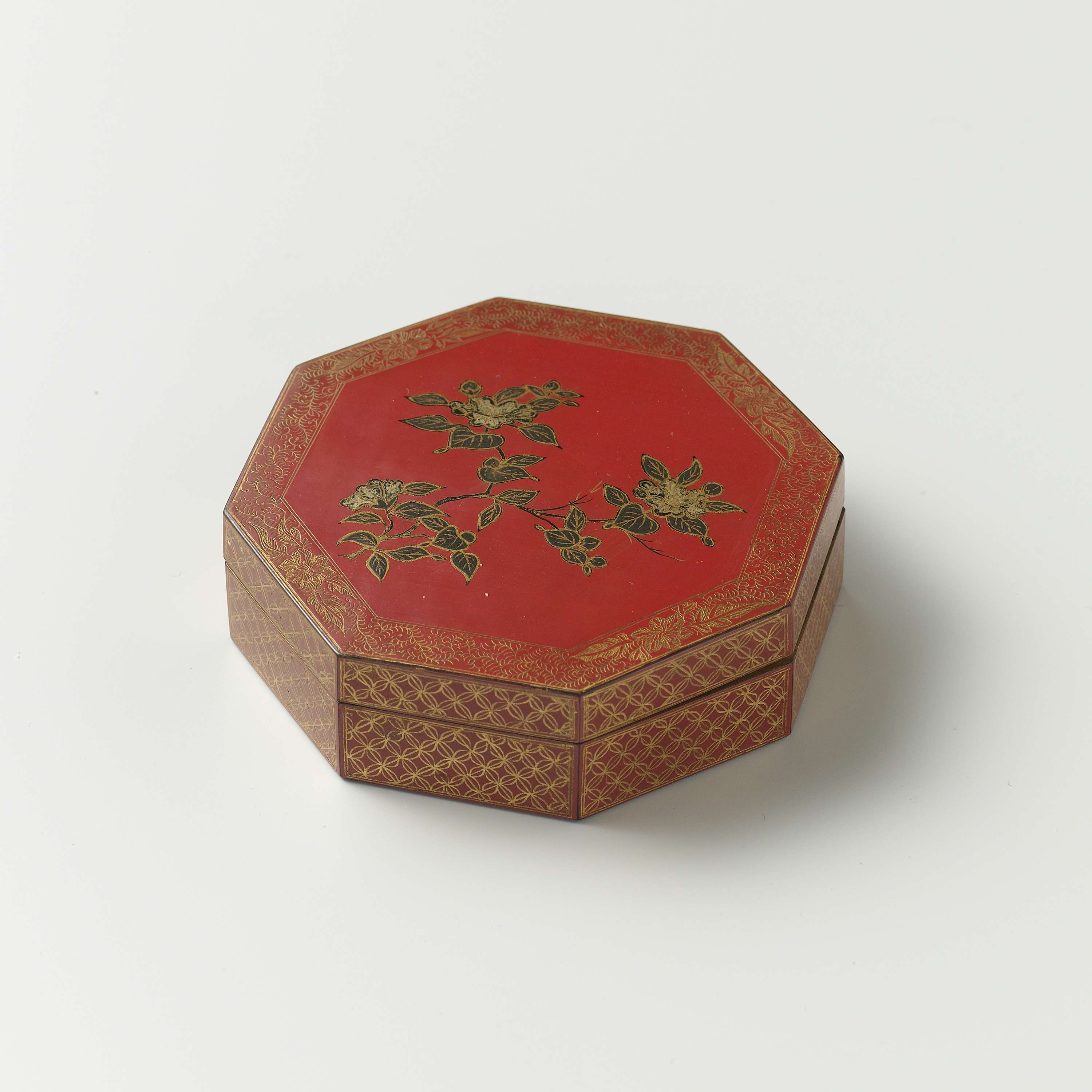 Lacquer box by Unknown Artist showcasing intricate carvings and light interplay.