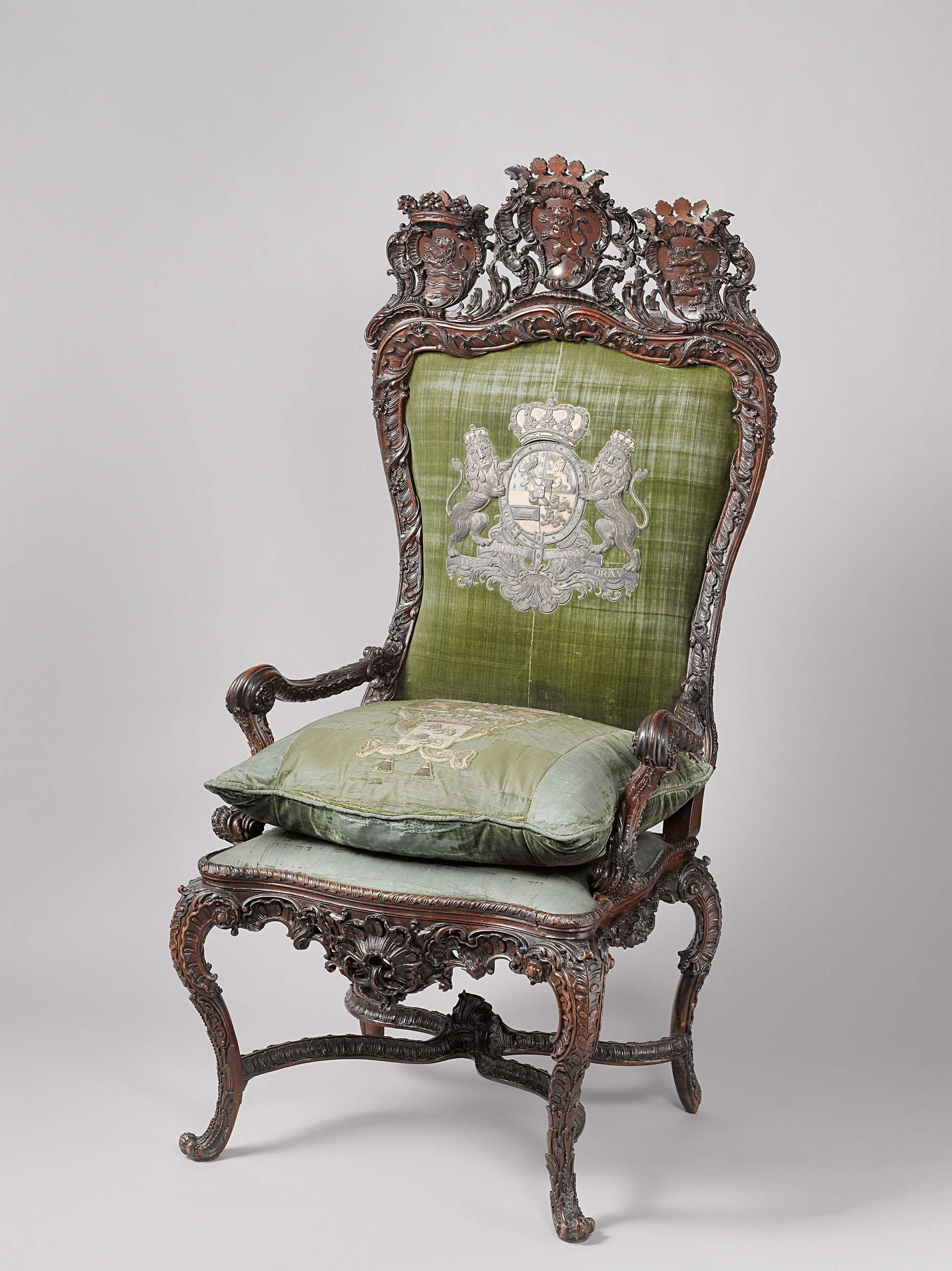 Rococo wood chair by Gerrit Hutte with intricate carvings and coat of arms.