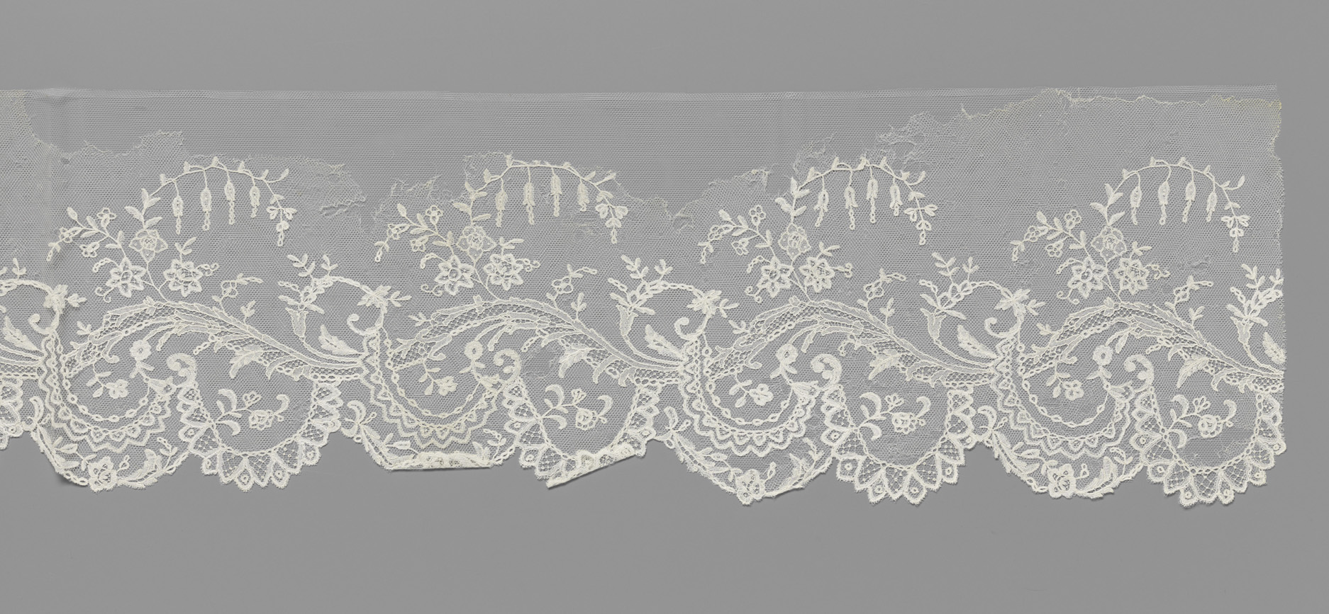 Lace artwork by Unknown Artist featuring floral motifs and intricate textures.