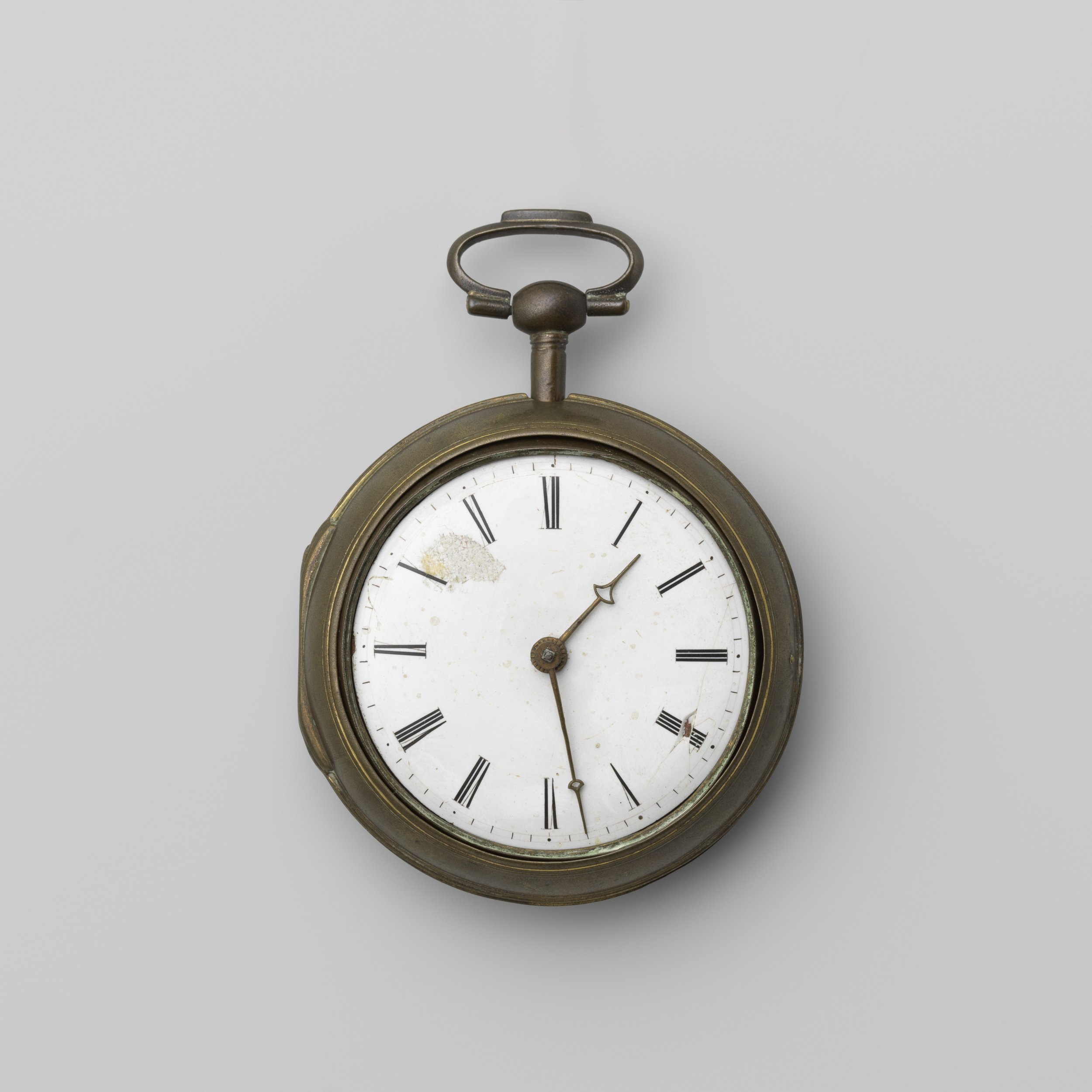 Still life of a metal clock by William Pybus, showcasing light and shadows.