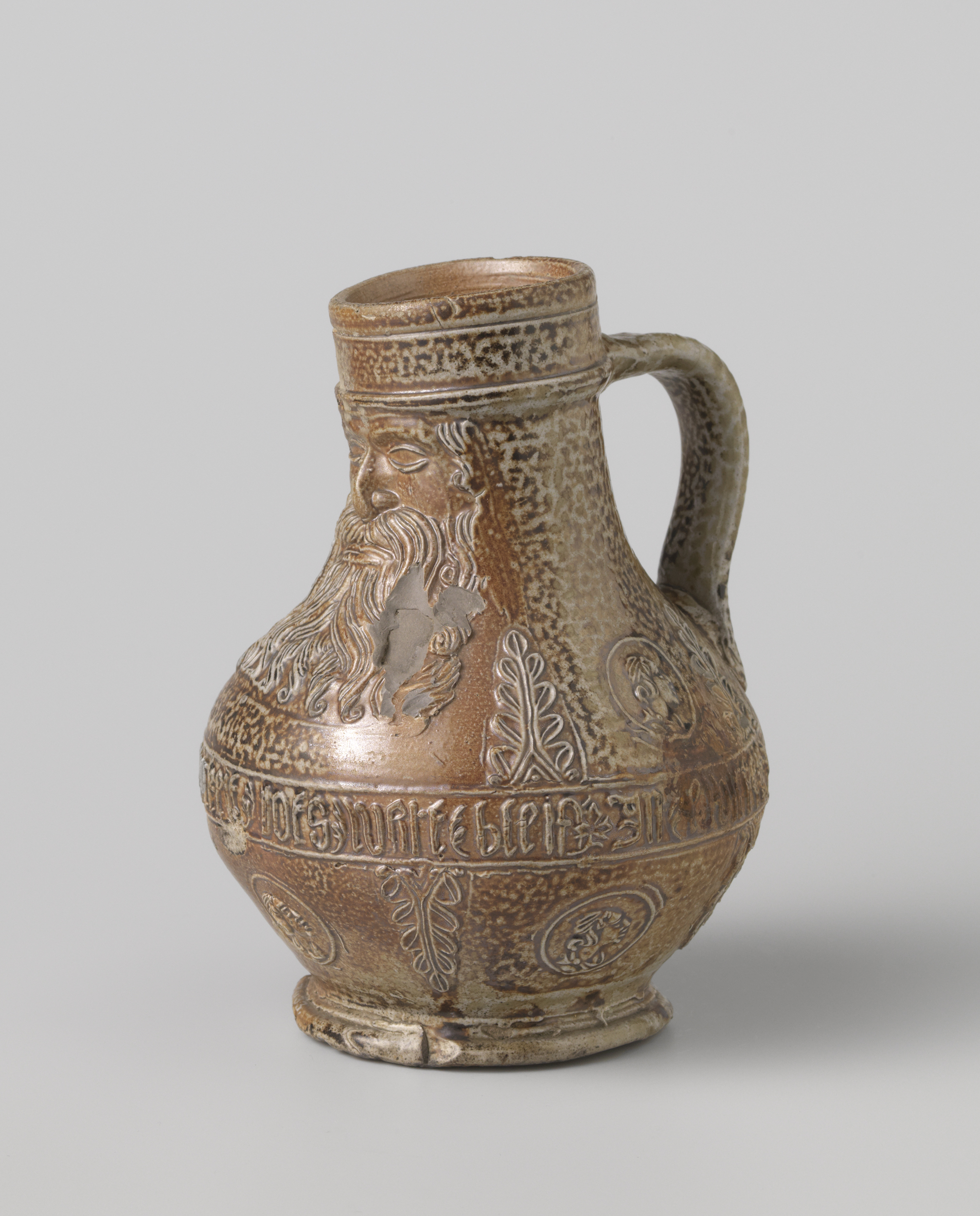 Ceramic jug with portraits and leaves by unknown artist