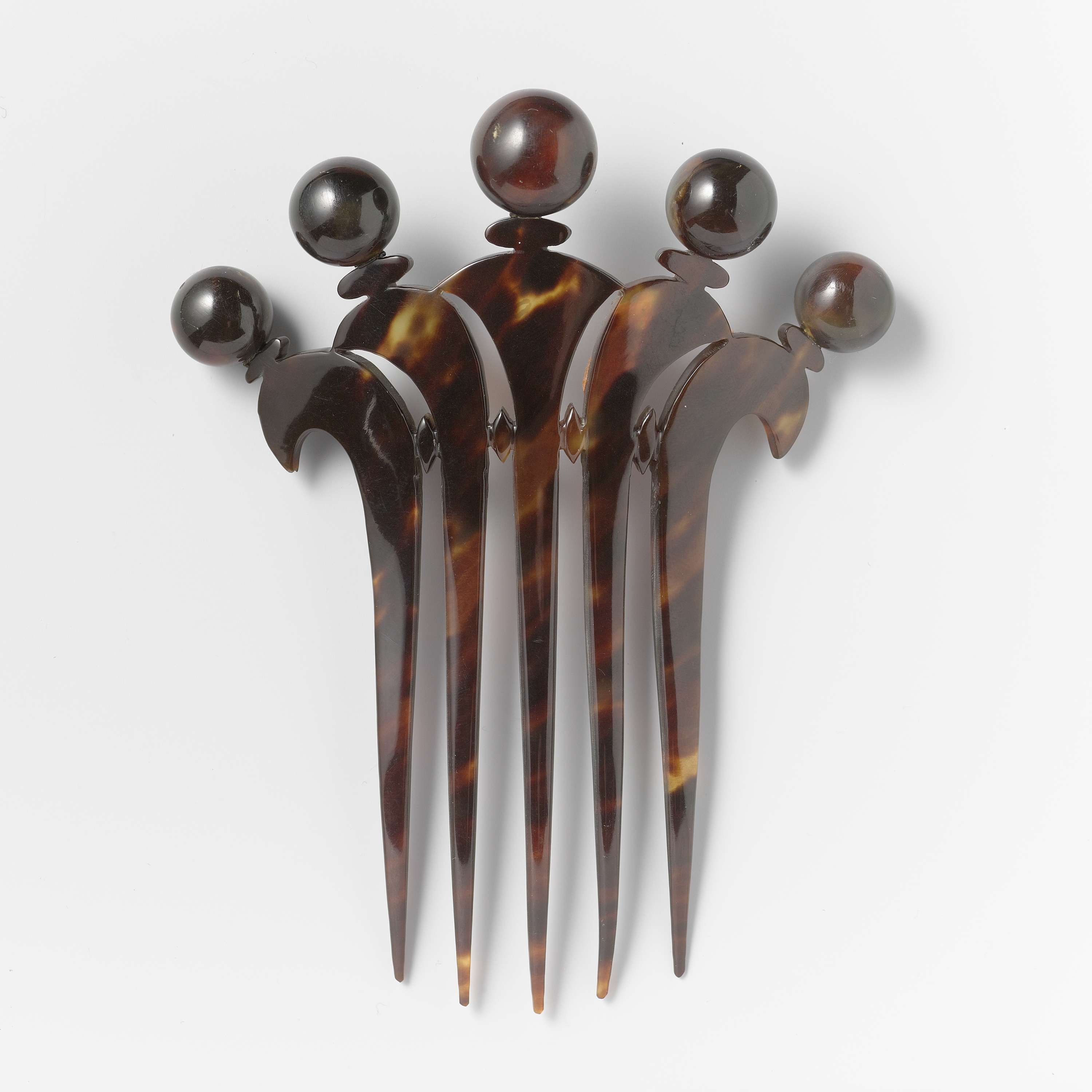 Decorative tortoiseshell comb by Unknown Artist, showcasing intricate design and craftsmanship.