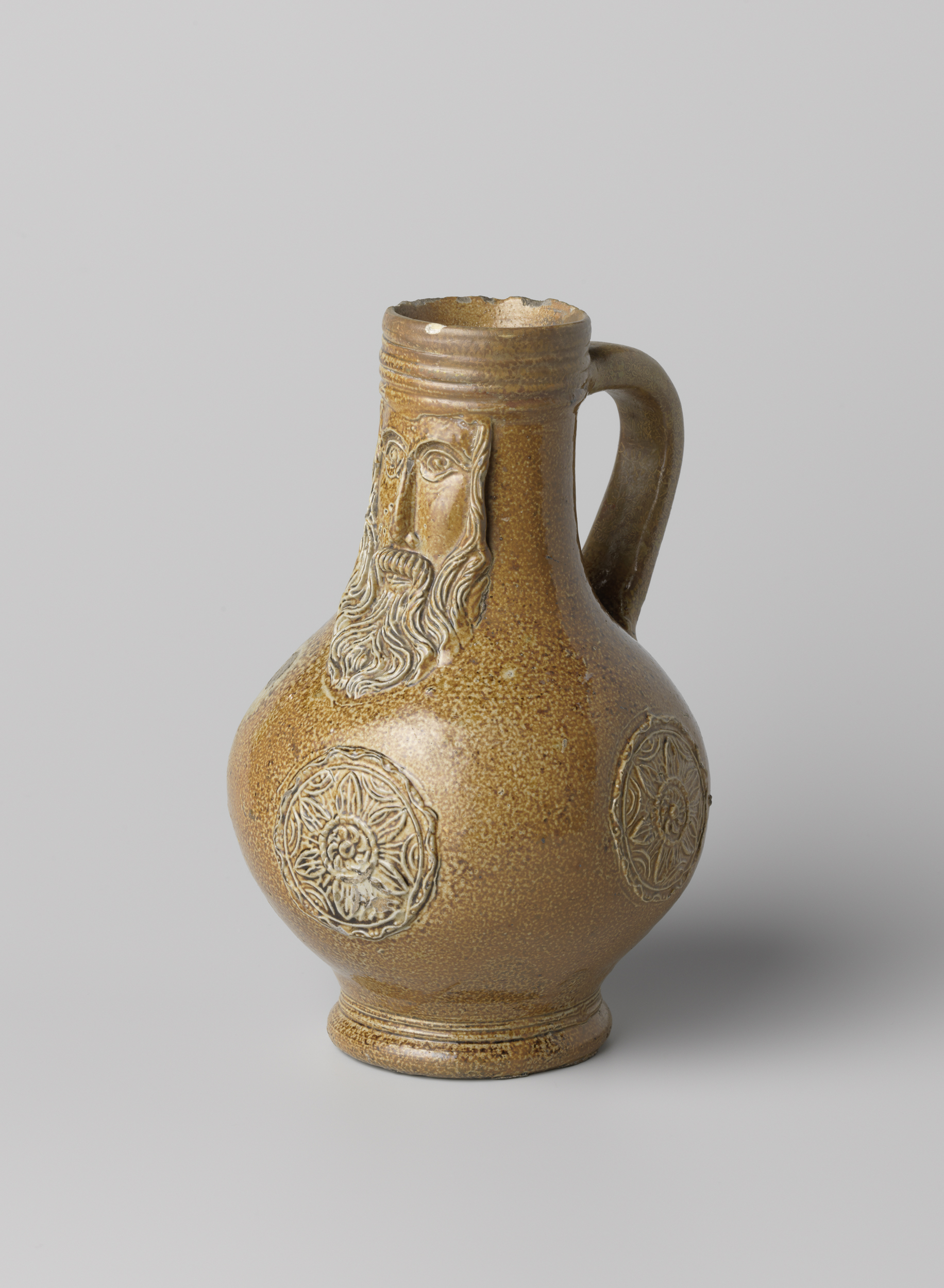 Bartmann jug made of stoneware by unknown artist, featuring intricate medallions.