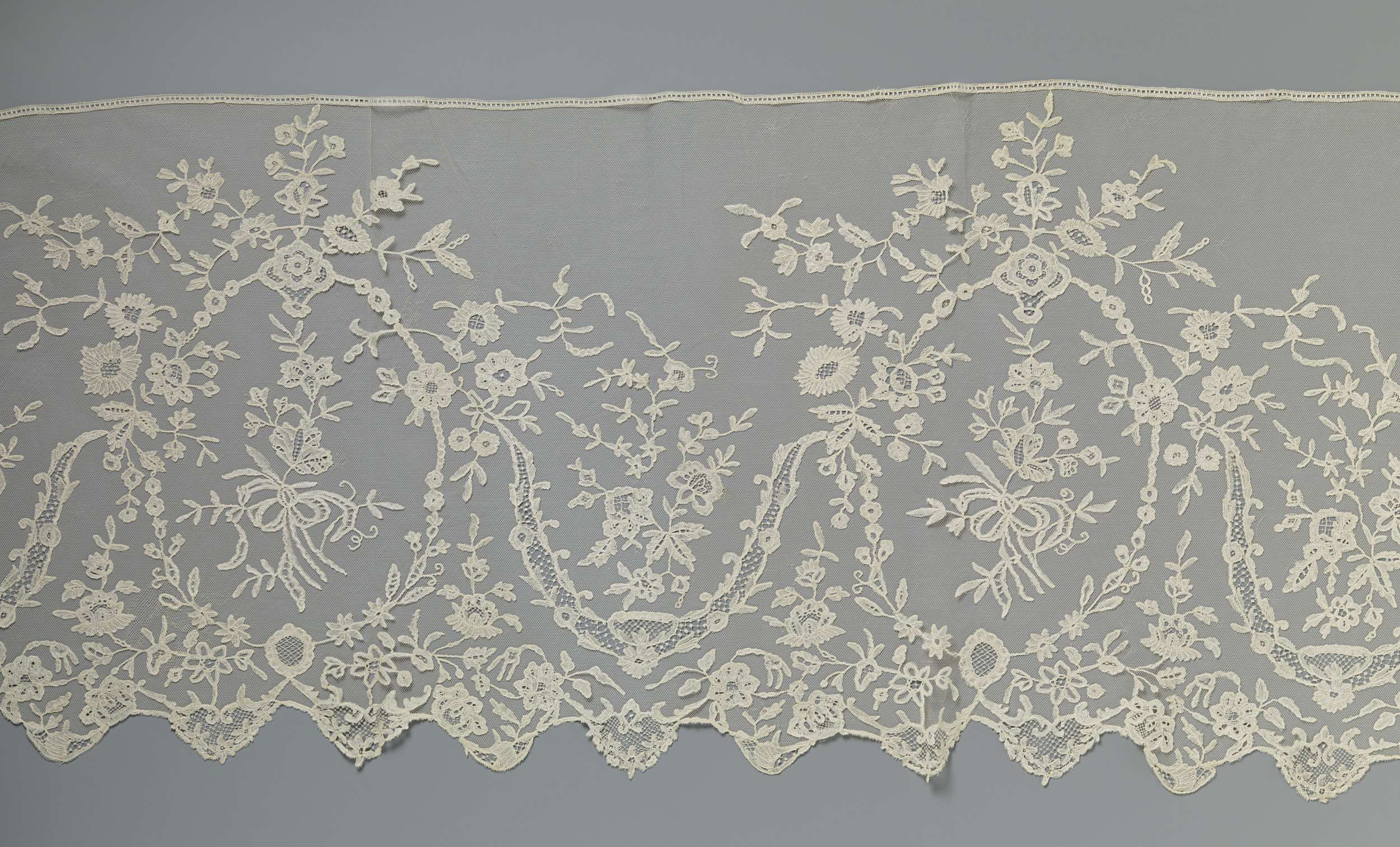 Lace textile by Unknown Artist featuring intricate patterns and vibrant colors.