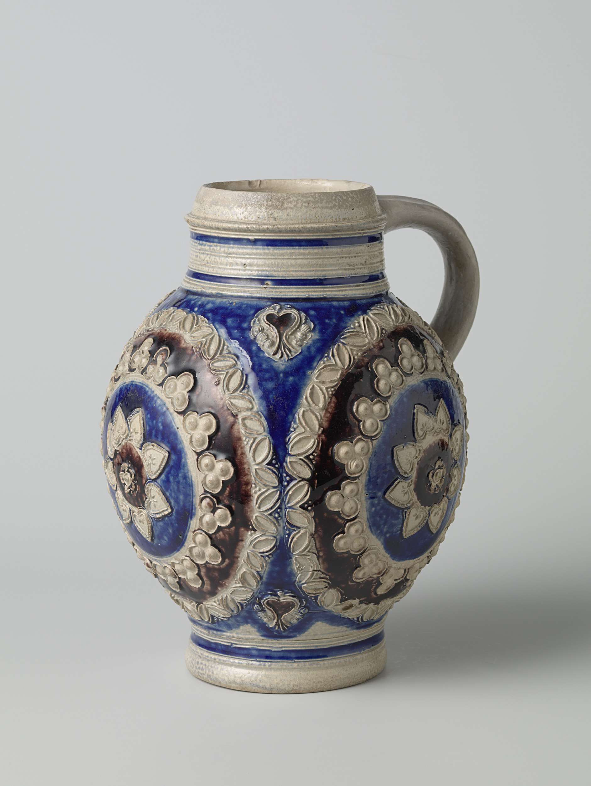 Ceramic jug with concentric circles and floral ornamentation, unknown artist