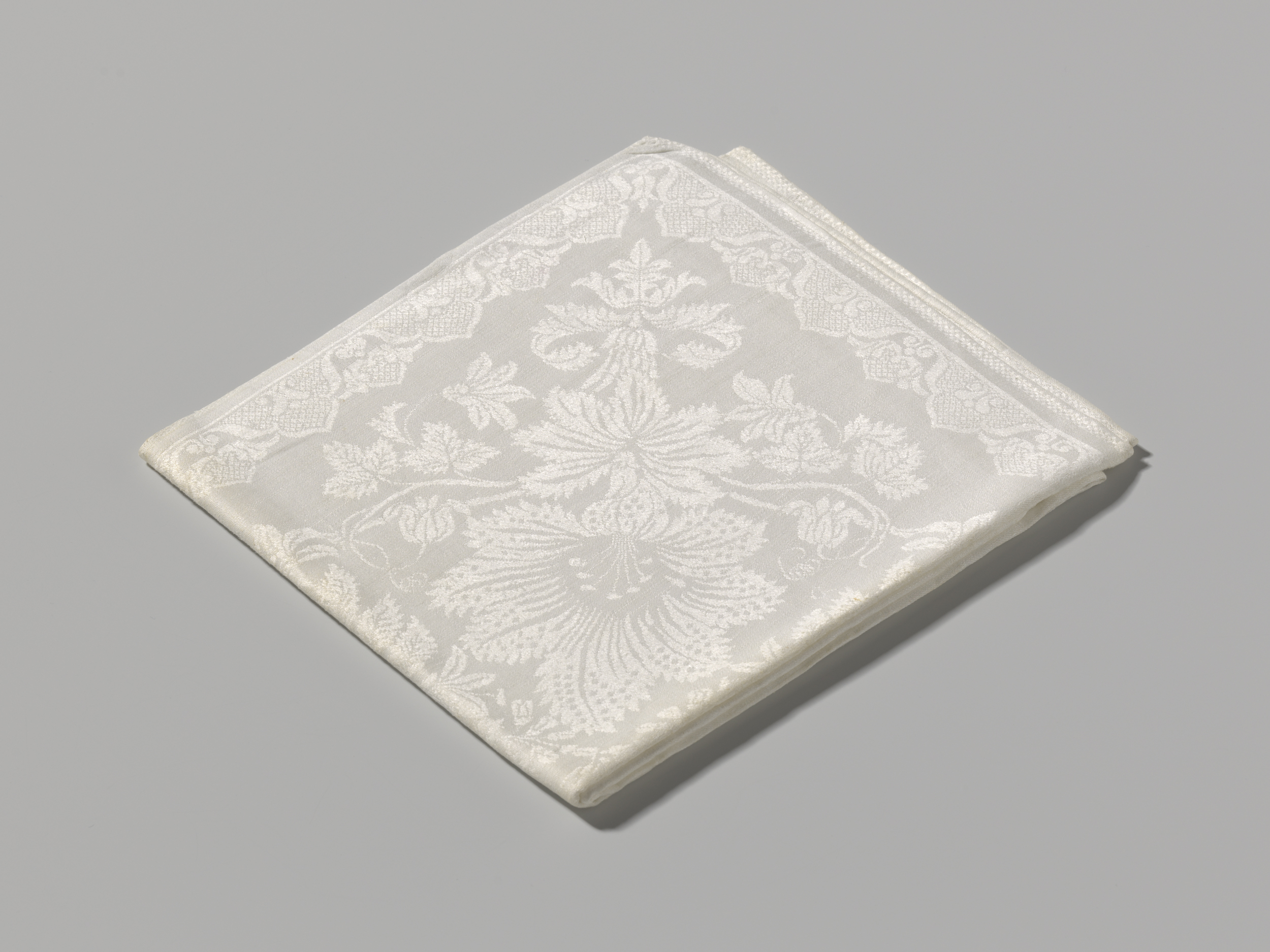 Decorative textile featuring floral patterns and gold accents by Unknown Artist