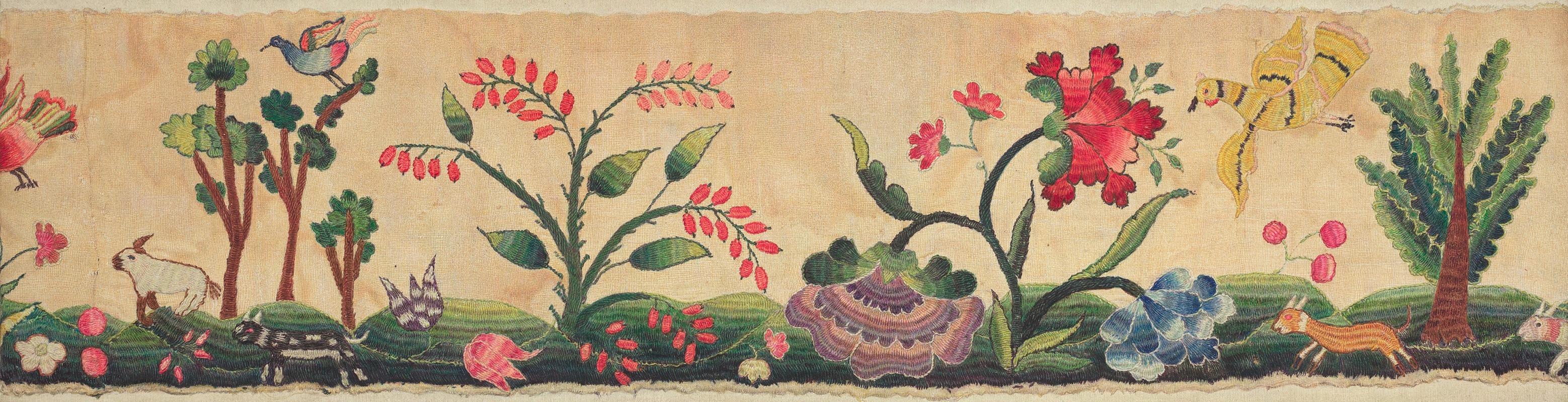 A detailed section of crewel embroidery showcasing intricate patterns and vibrant colors.