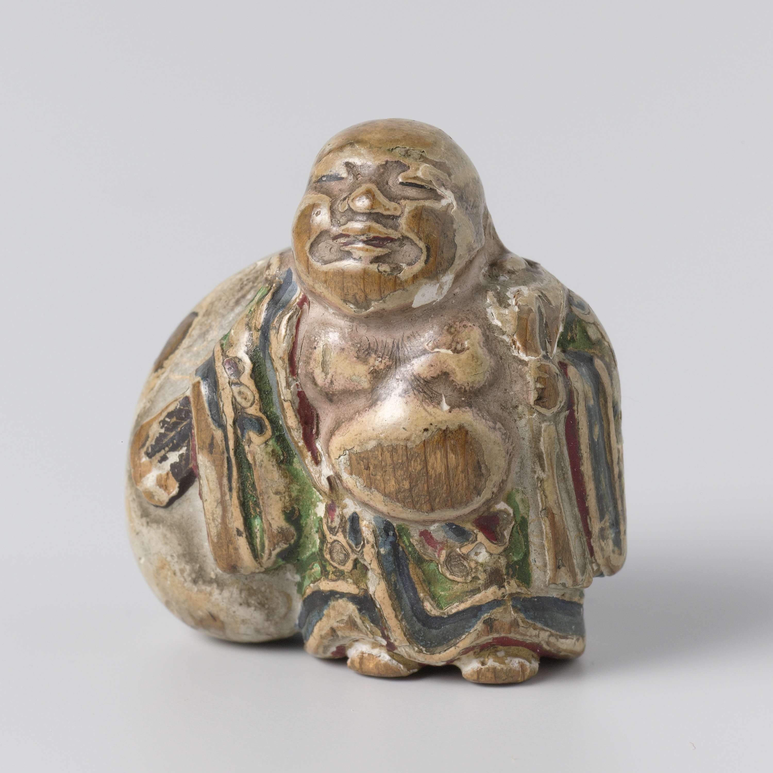 Netsuke by unknown artist, wood carving featuring intricate details and tiny figures.