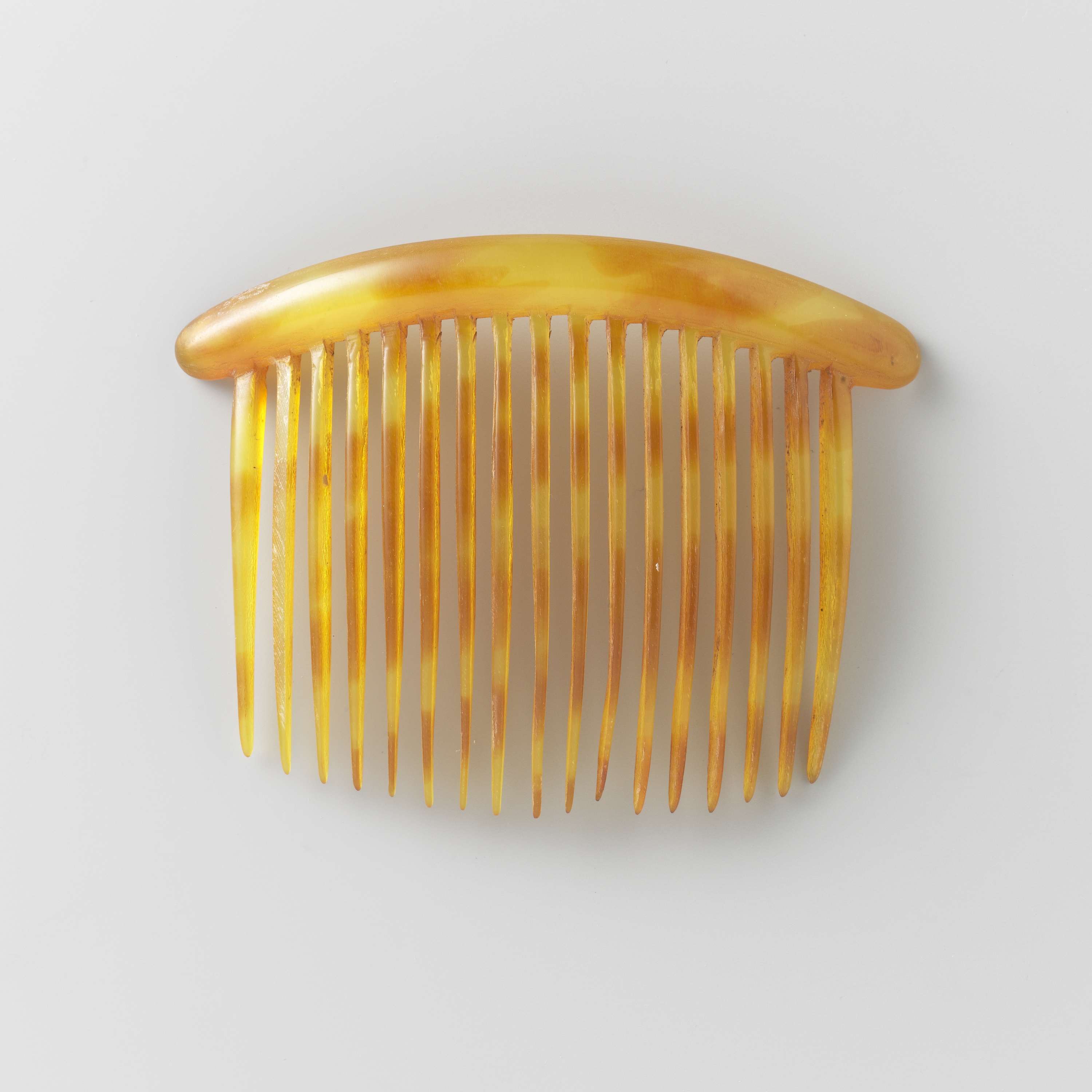 Ornate hair comb made of imitation tortoiseshell by Unknown Artist