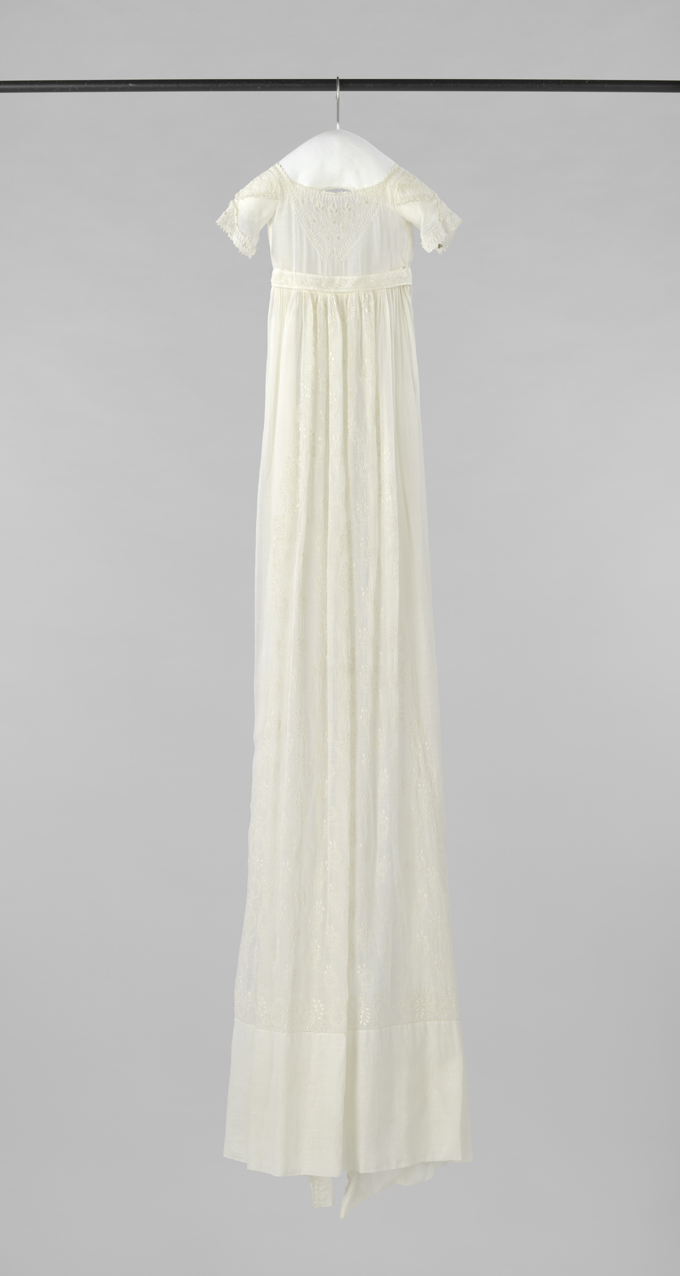 Embroidery of a baptismal gown with curving branches by Unknown Artist