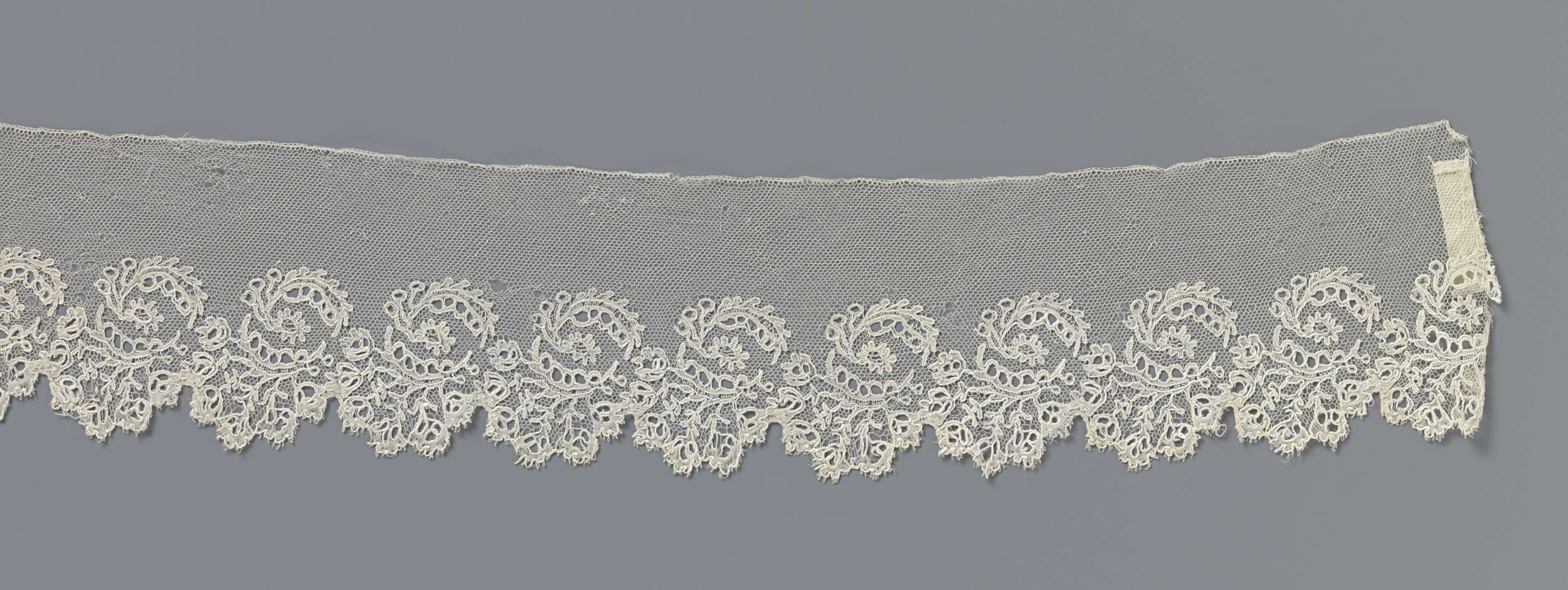 Lace artwork by Unknown Artist featuring an oval shape surrounded by bent leaves.