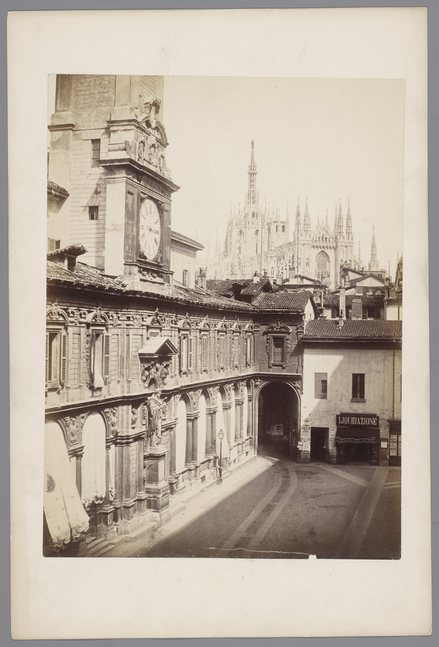 Albumen print by Pompeo Pozzi depicting a street scene with a cathedral in Milan.