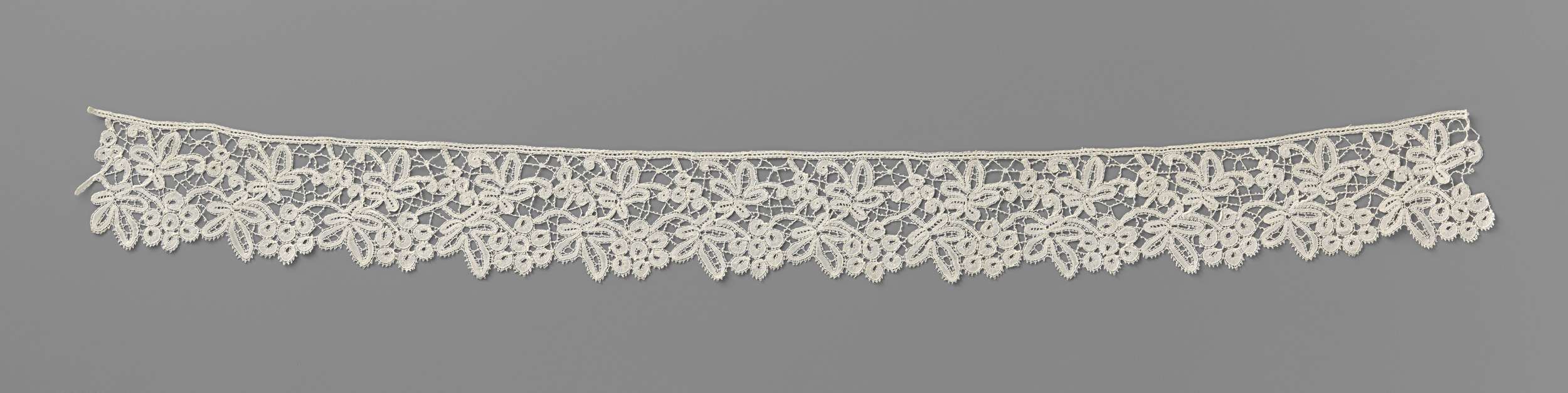 Lace artwork by Unknown Artist featuring a three-leaf motif and intricate shadows.
