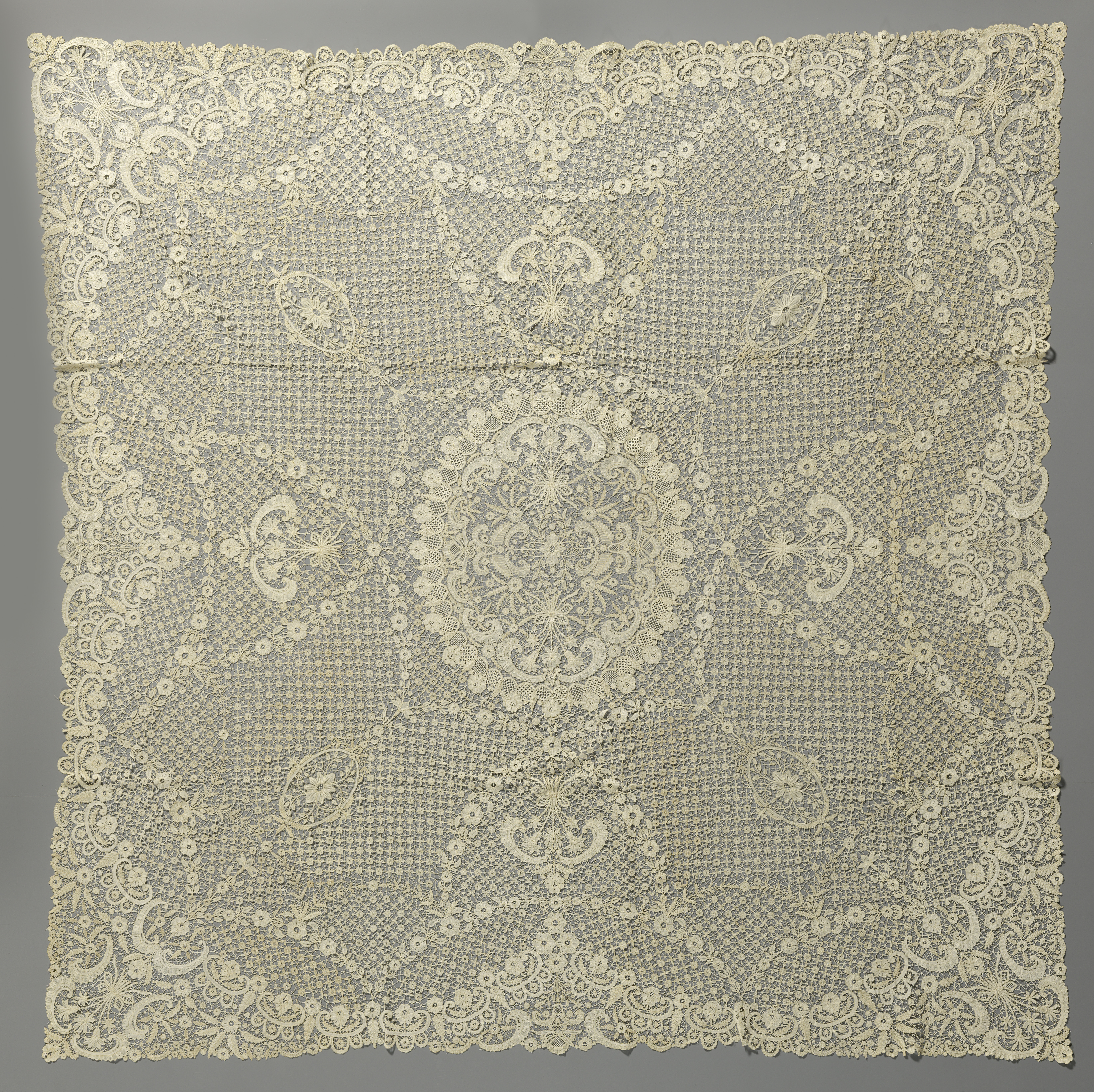 Lace textile by Annie Roos featuring vibrant flowers, c. 1918-1920