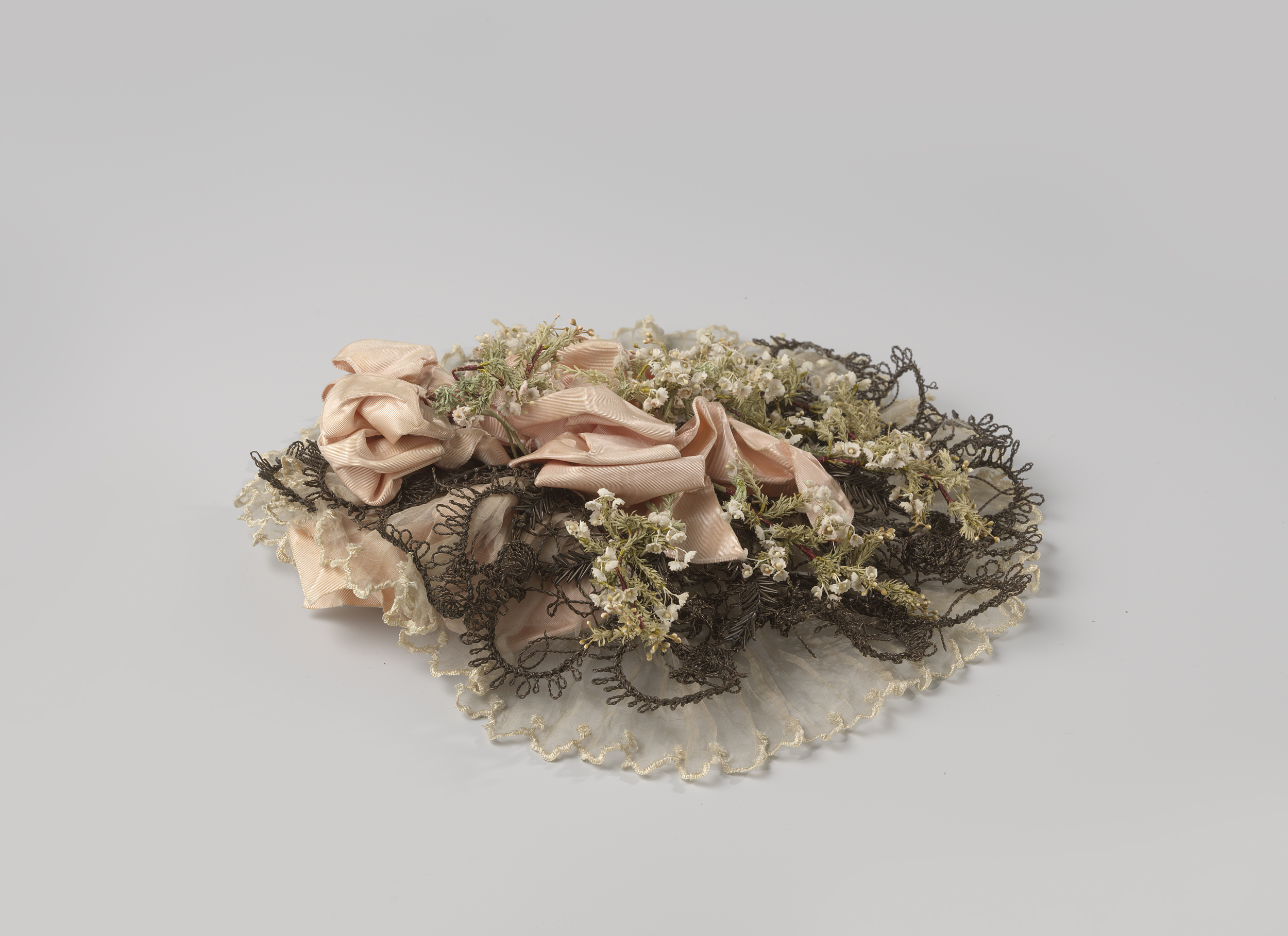 Victorian decorative art hat with pink silk netting and artificial flowers by Unknown Artist