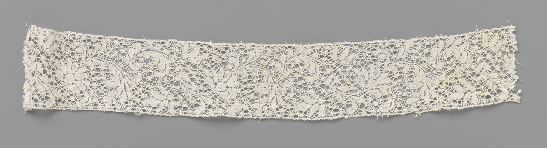 Lace artwork featuring a flower and feather by Unknown Artist