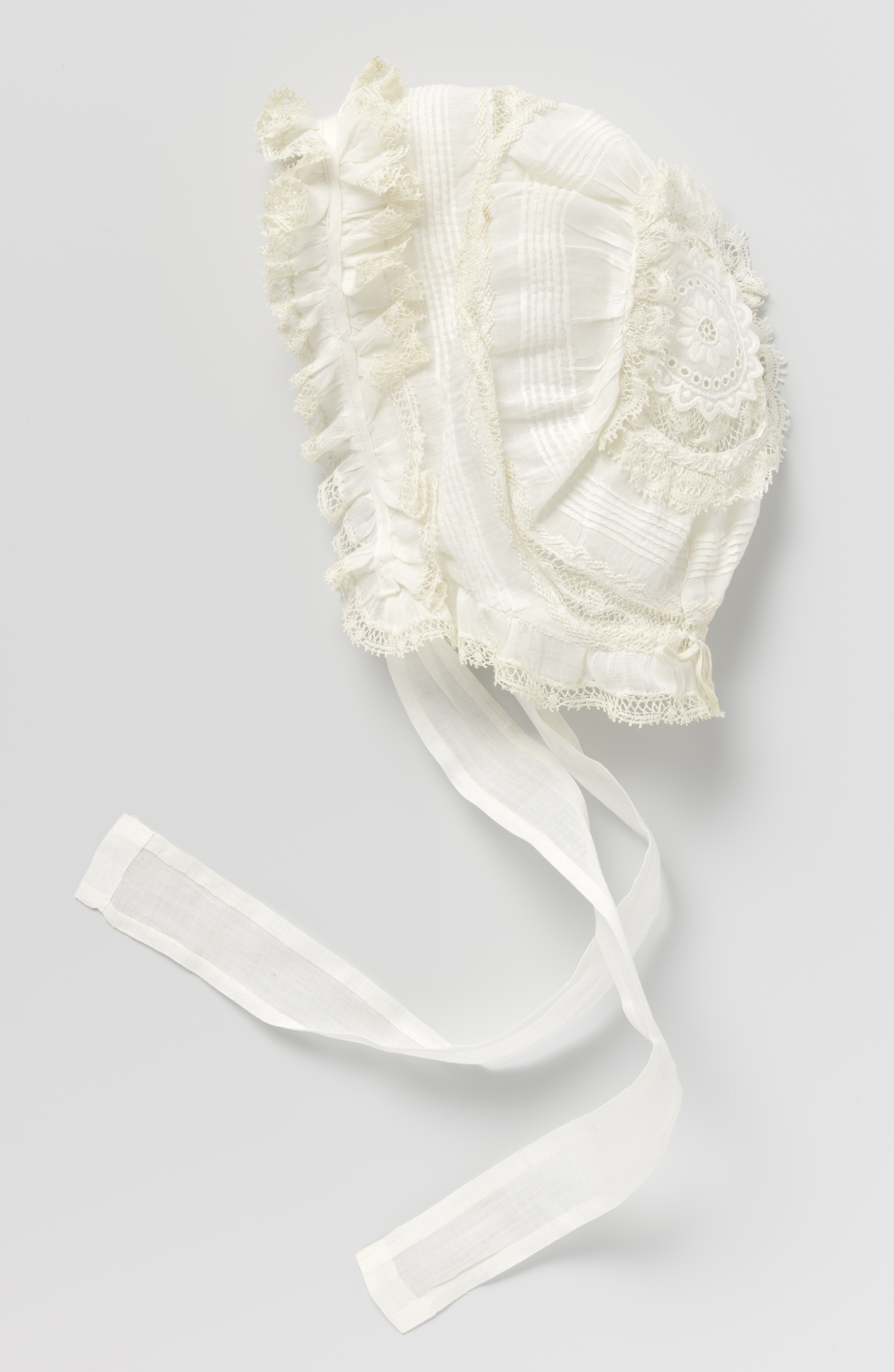 Textile work featuring white fabric, embroidery, and lace by Unknown Artist