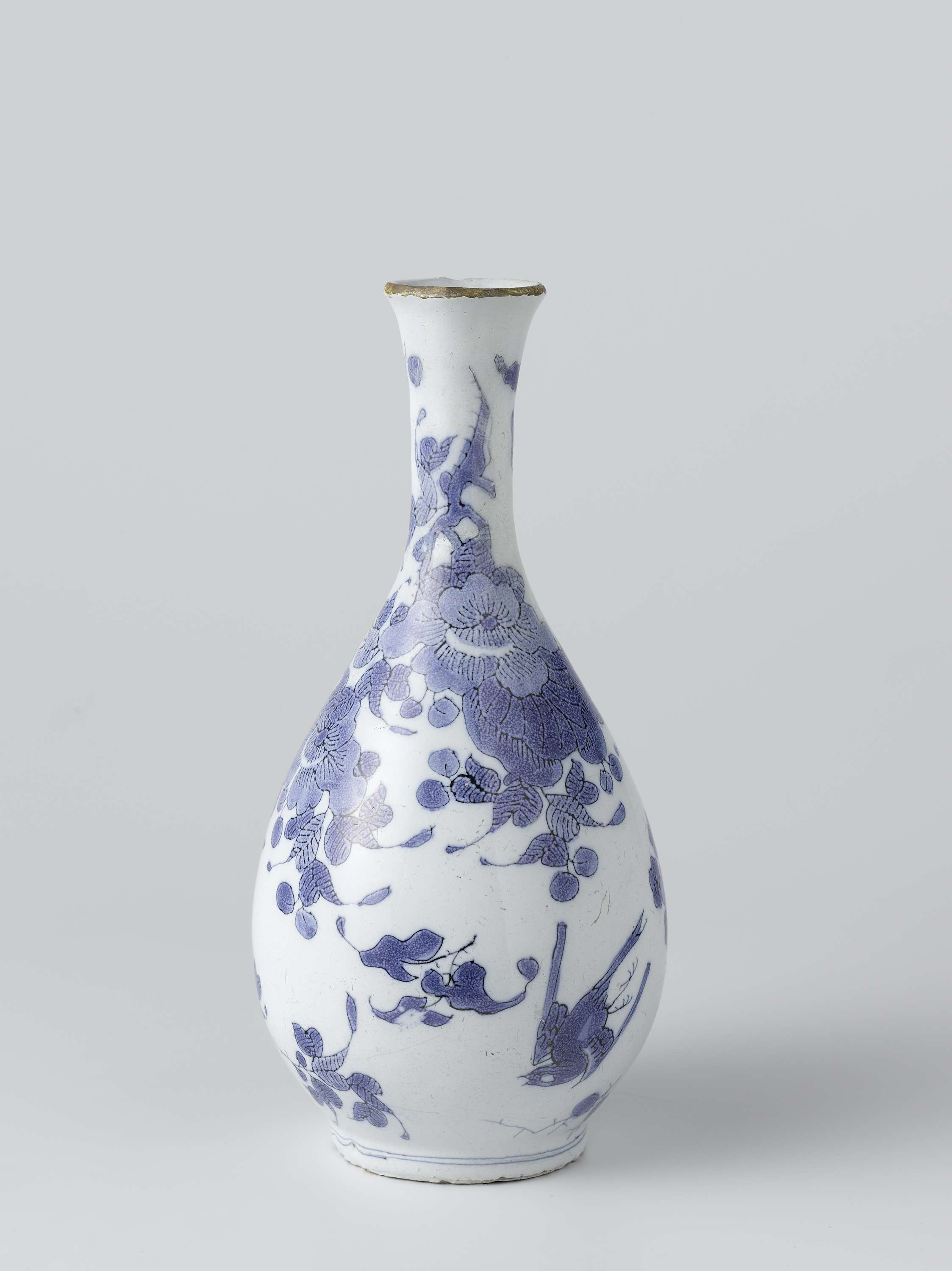 Still life of a white earthenware vase with colorful flowers by Het Moriaanshooft