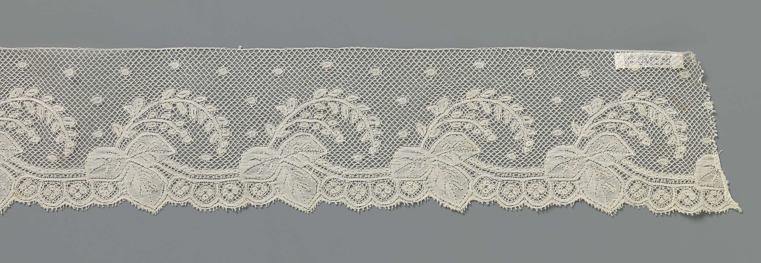 Lace artwork by Unknown Artist featuring intricate vine leaves.