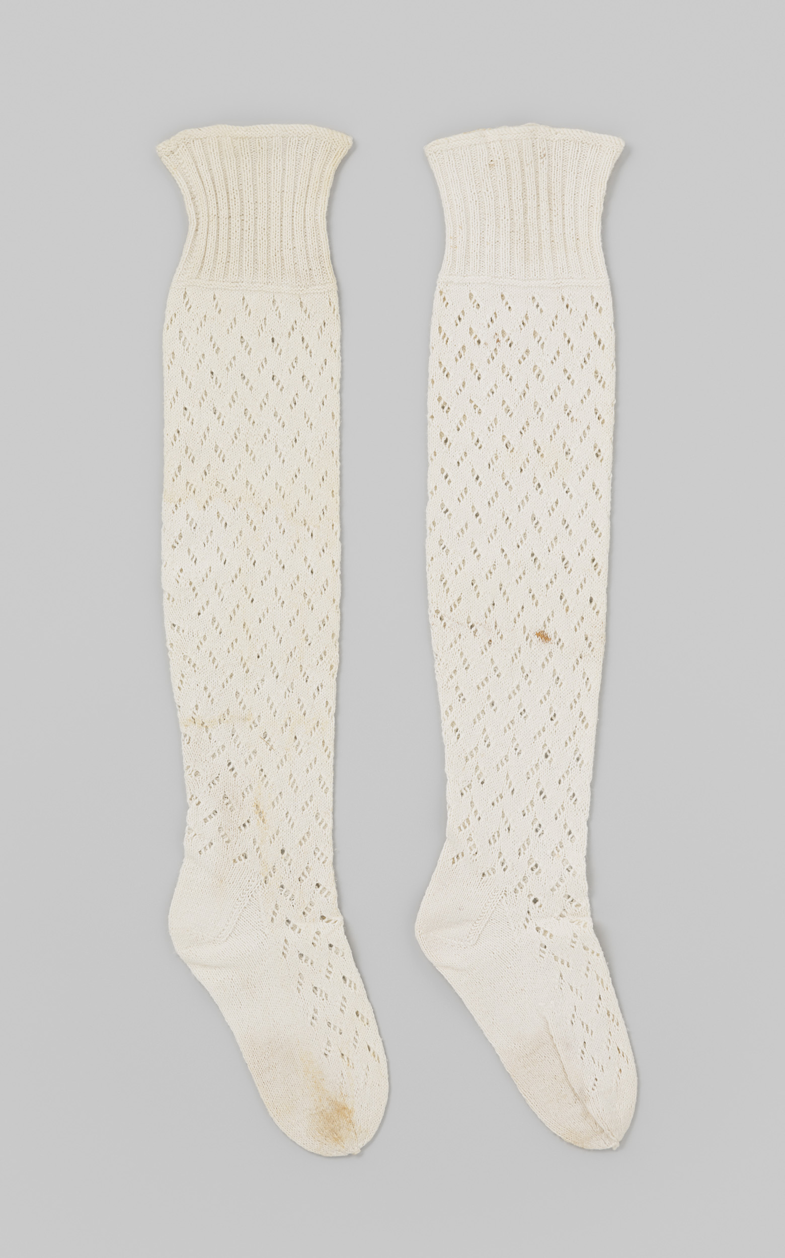 Textile garment in white cotton with ajour knitting by Unknown Artist
