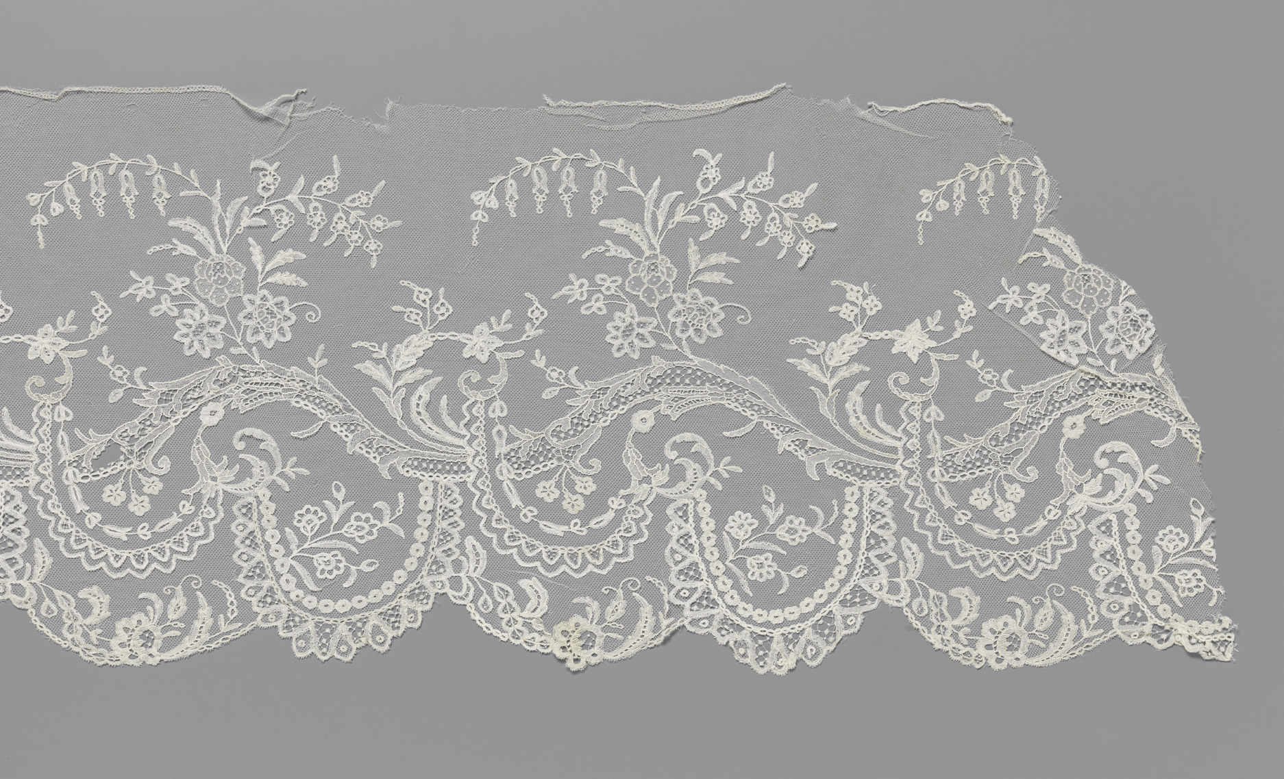 Lace artwork by Unknown Artist featuring floral motifs and intricate patterns.