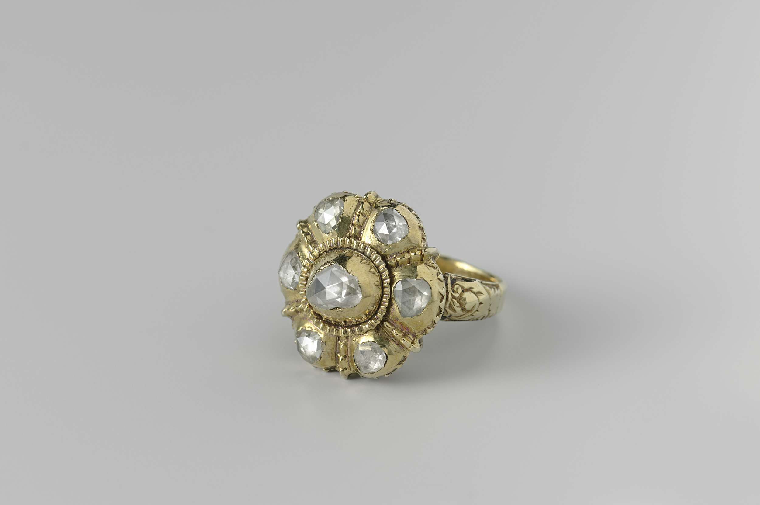 A delicate enamel ring by an unknown artist, showcasing intricate details and soft glint.