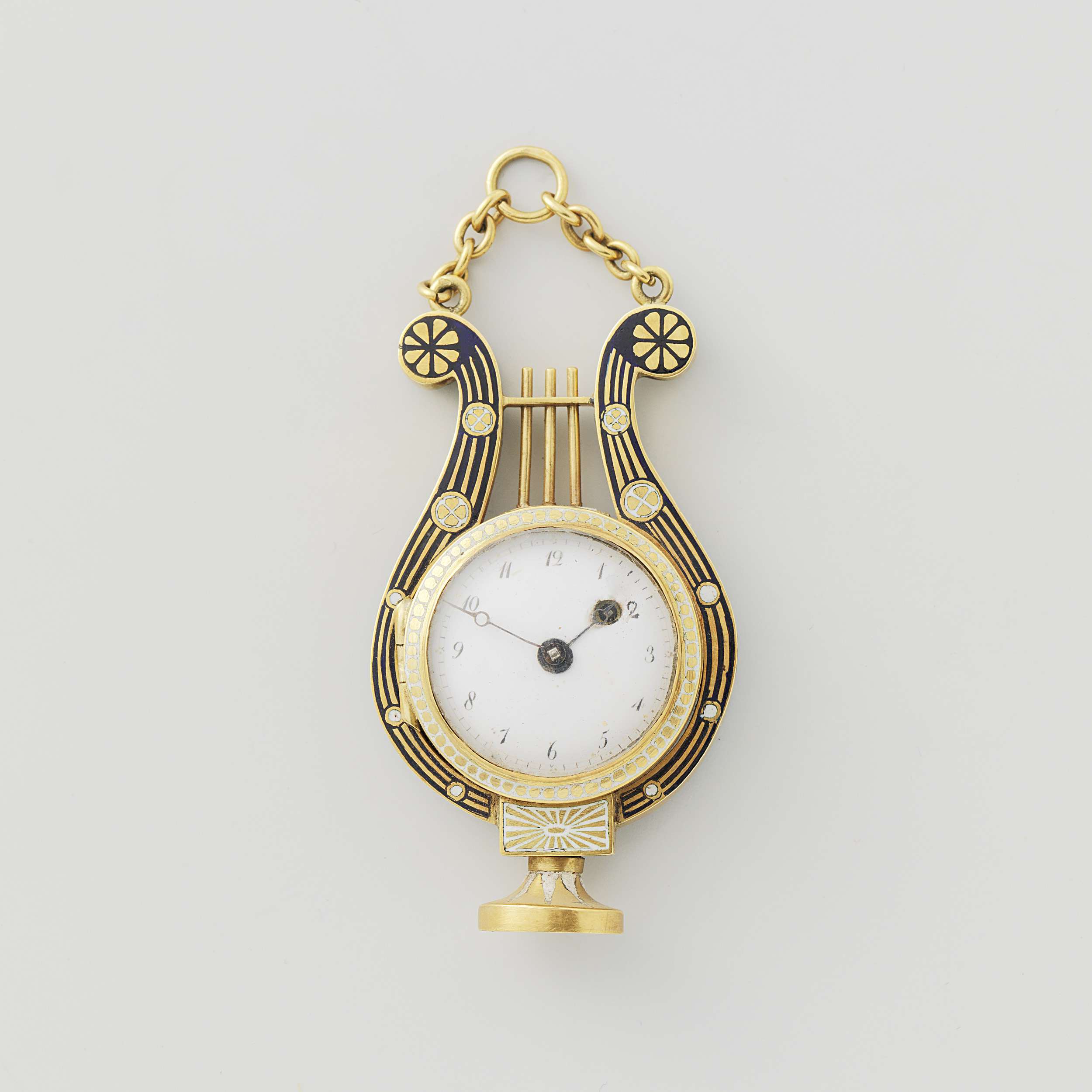 Lyre-shaped watch made of metal by Breguet & Fils, featuring intricate filigree and gold casing.