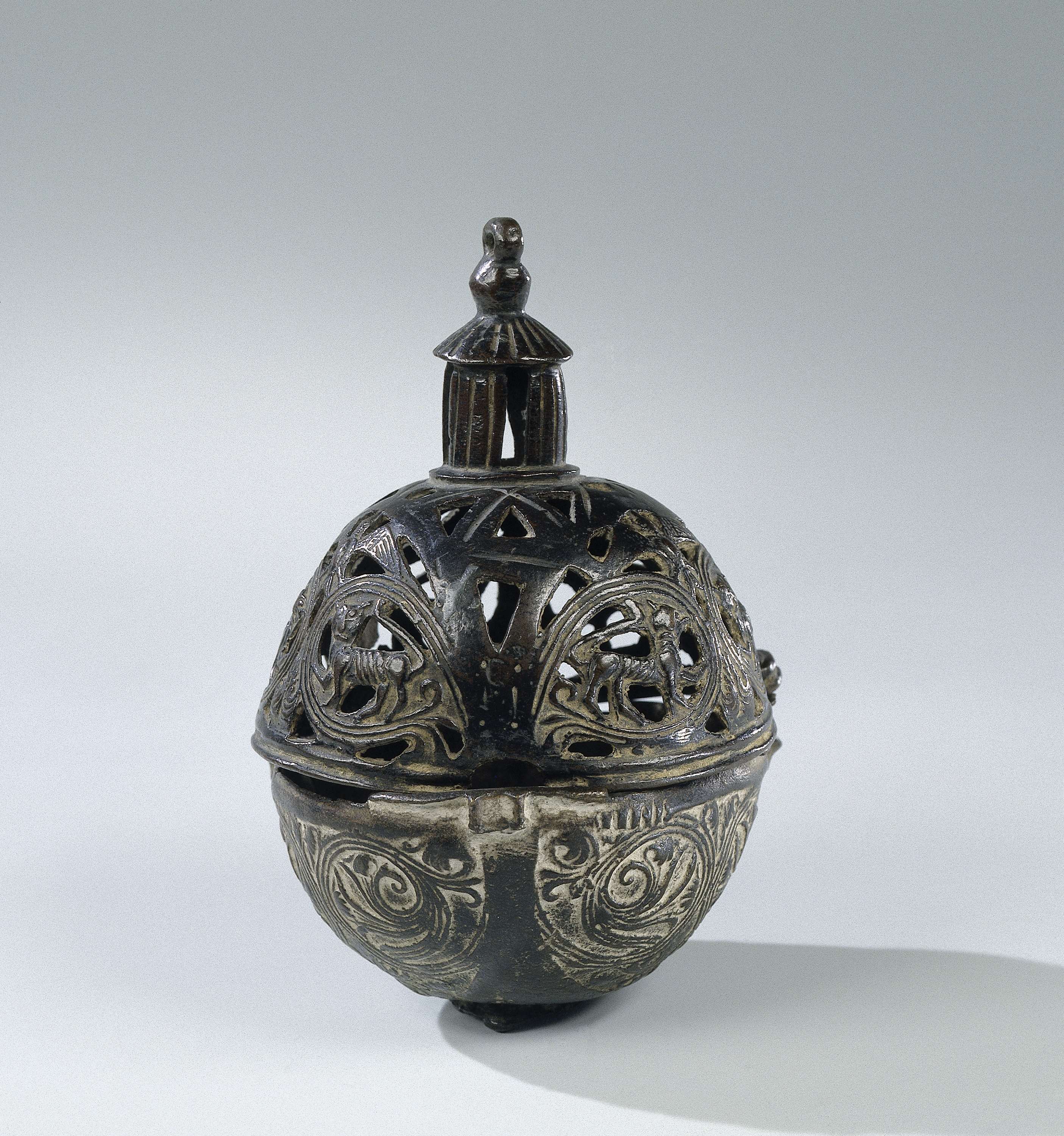 Bronze bolvormig incense burner with intricate carvings by unknown artist