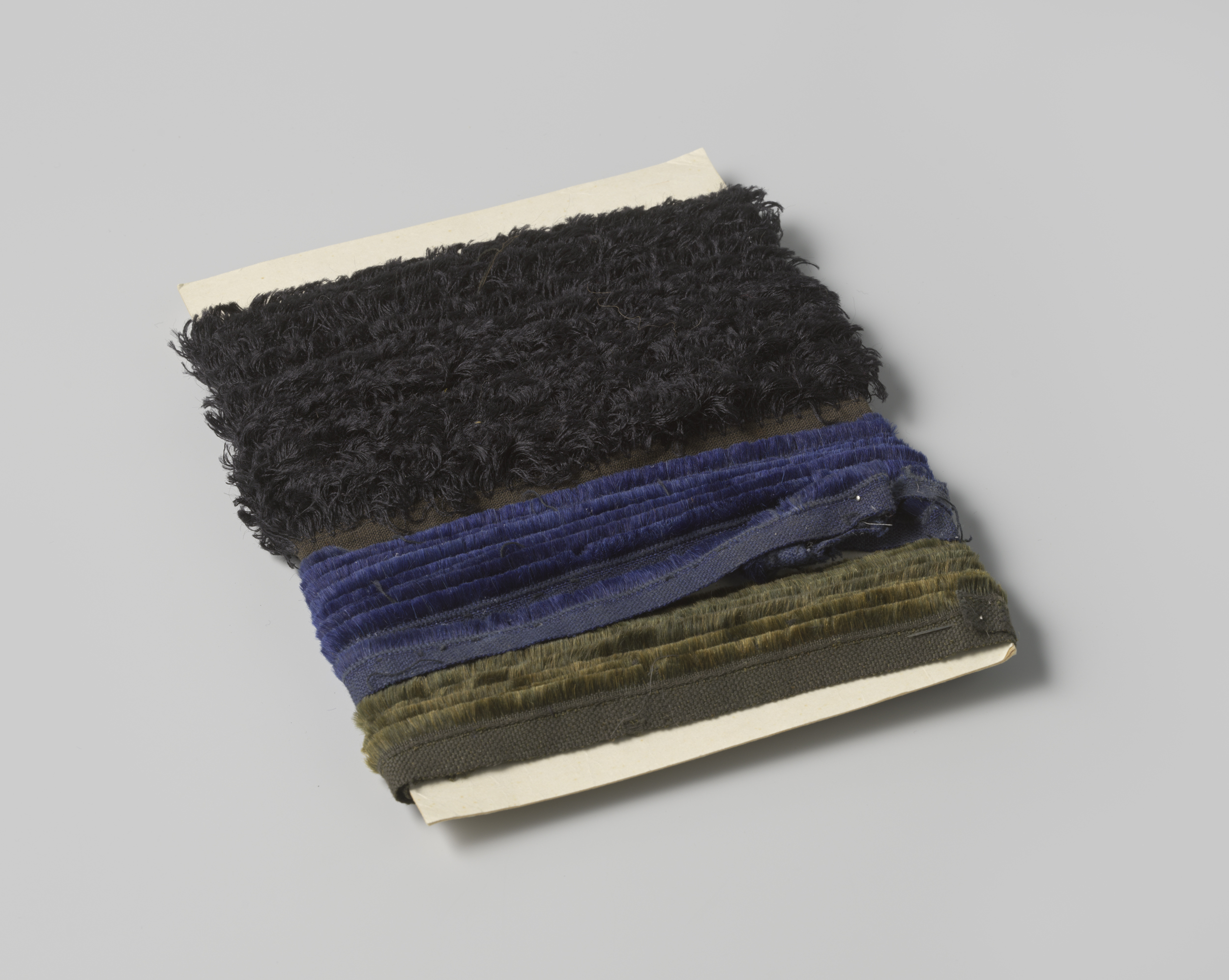 Abstract work by Gustav Schnitzler, ink on cardboard featuring black fringe.