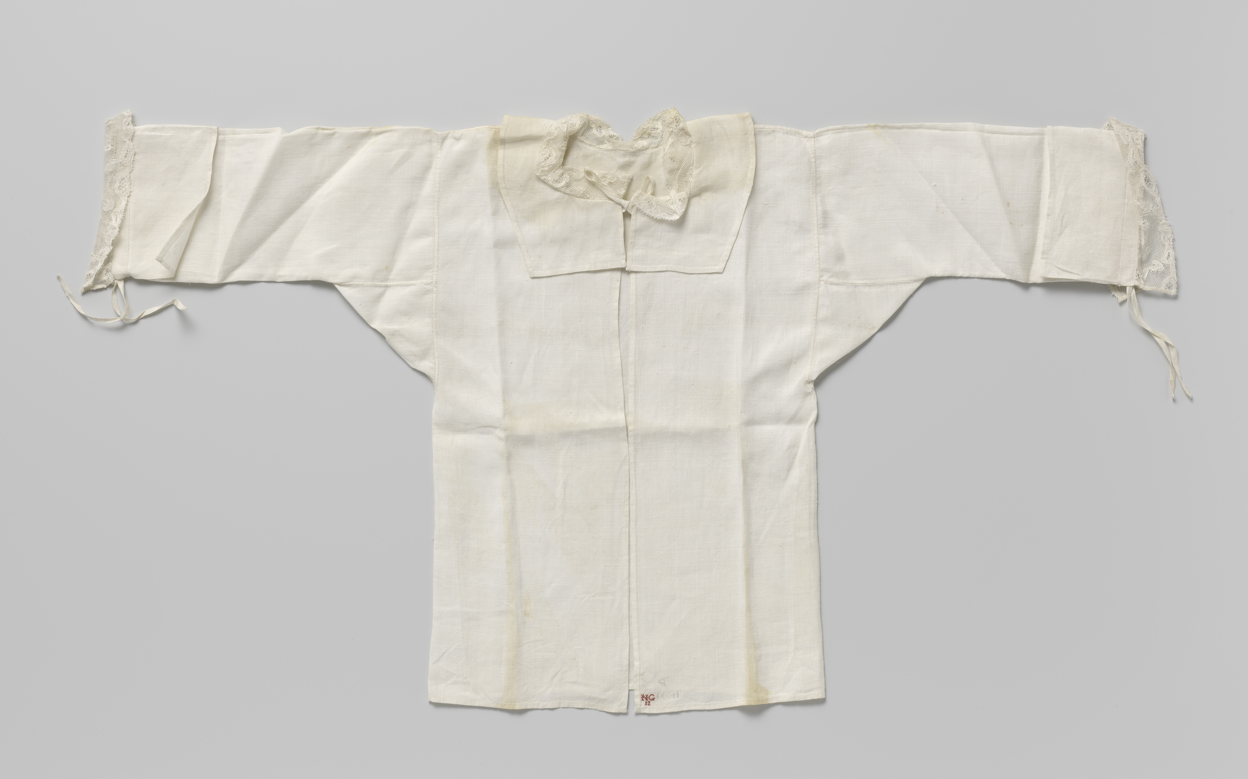 Victorian decorative art piece featuring a linen chemise with red embroidery by Unknown Artist.