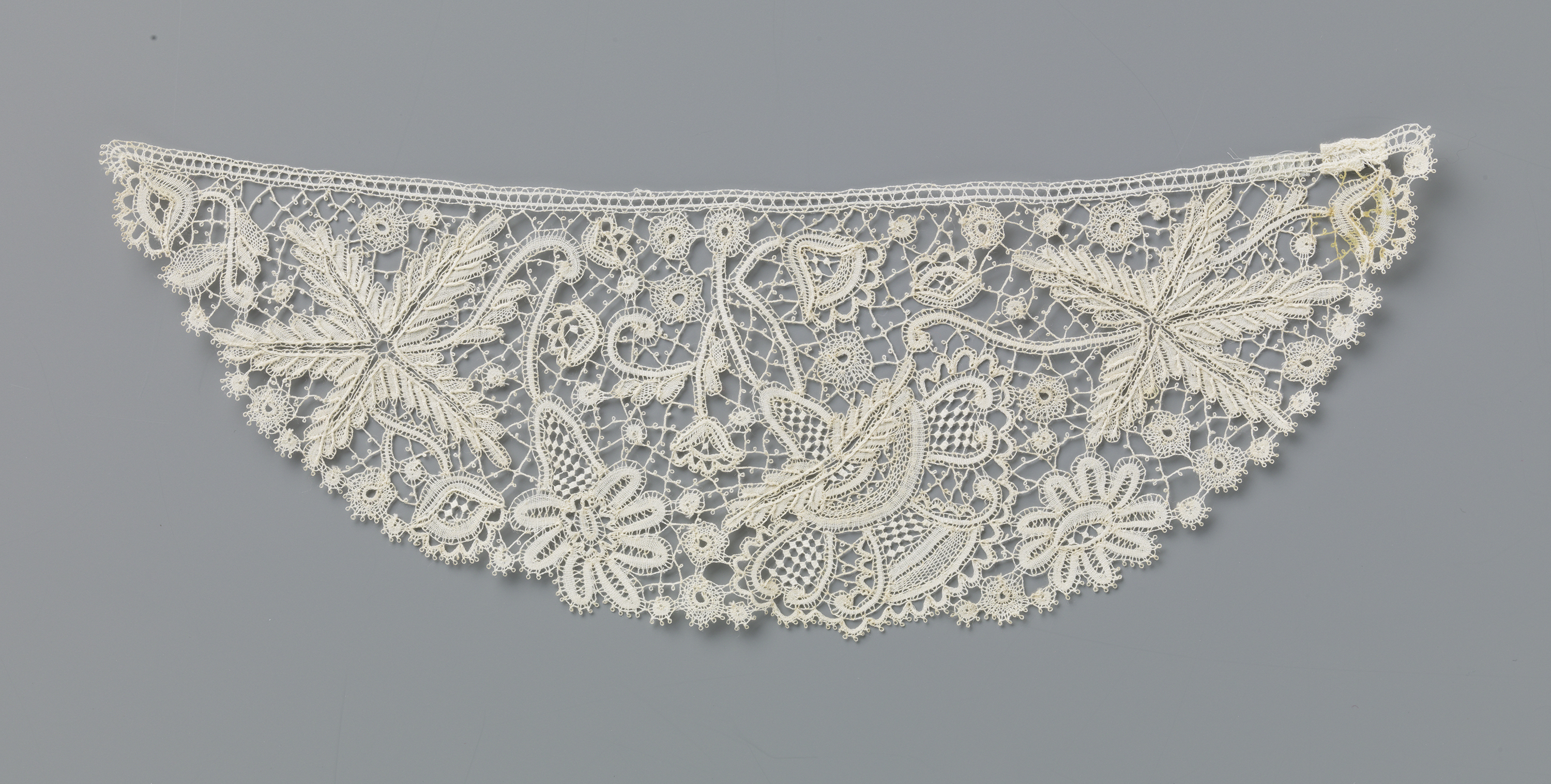 Lace textile by Martha Berkers featuring floral motifs and intricate design.