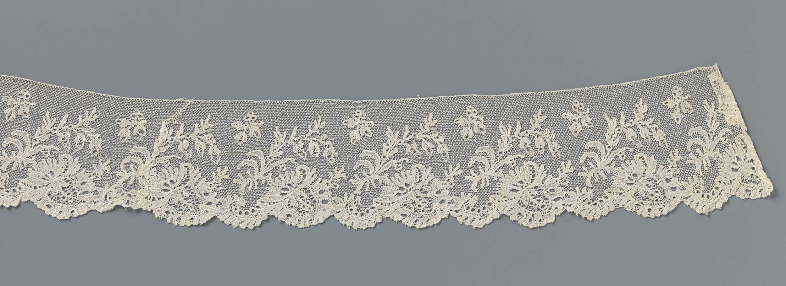 Lace work featuring a flower under a slanted branch by Unknown Artist