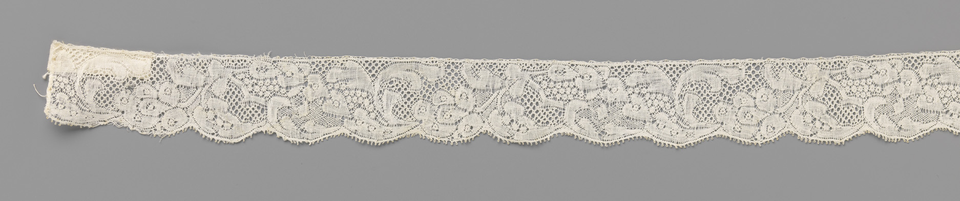 Lace work featuring heart-shaped leaves and a flower stem by Unknown Artist
