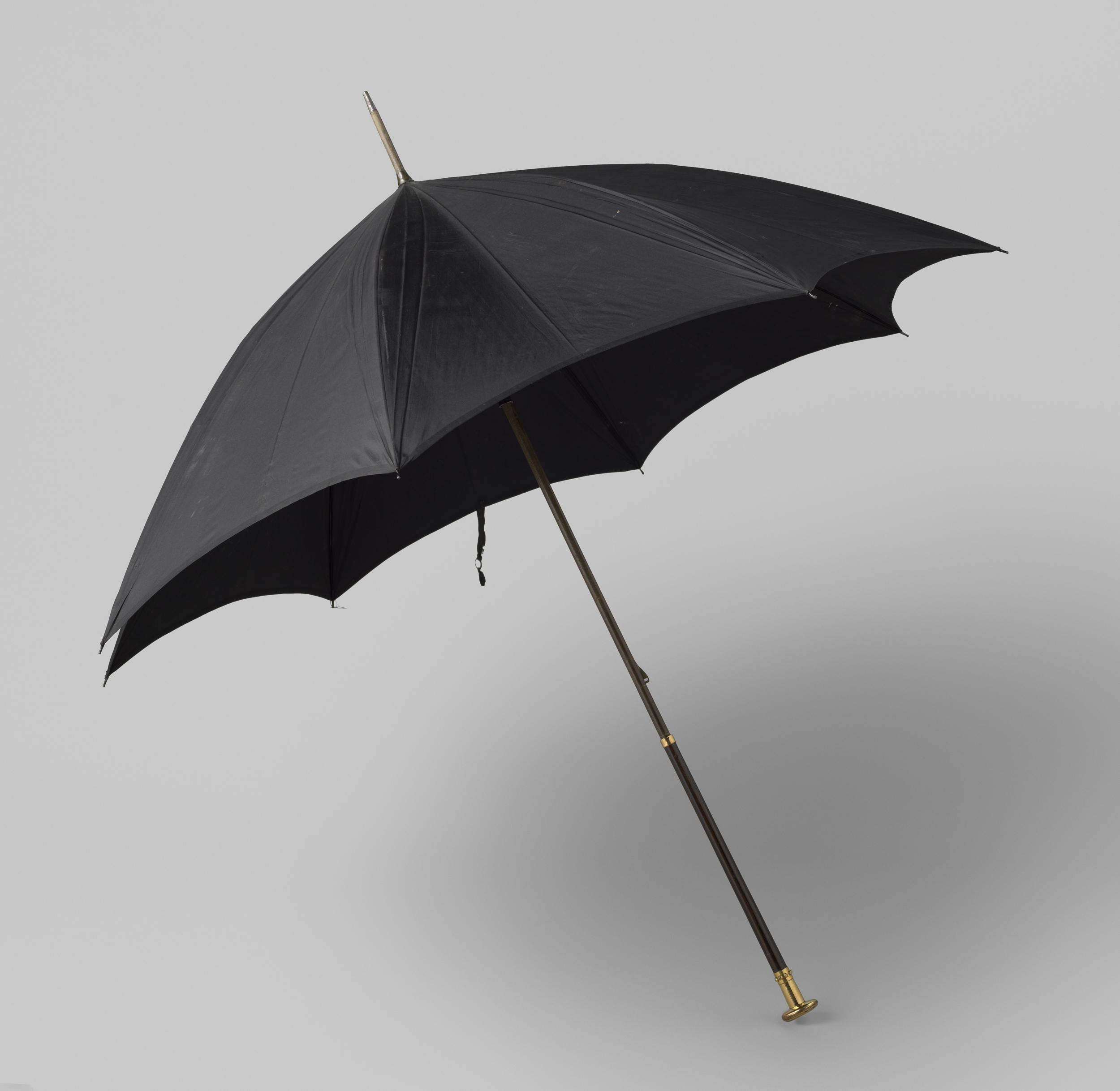 Decorative art featuring a black silk umbrella by Brigg