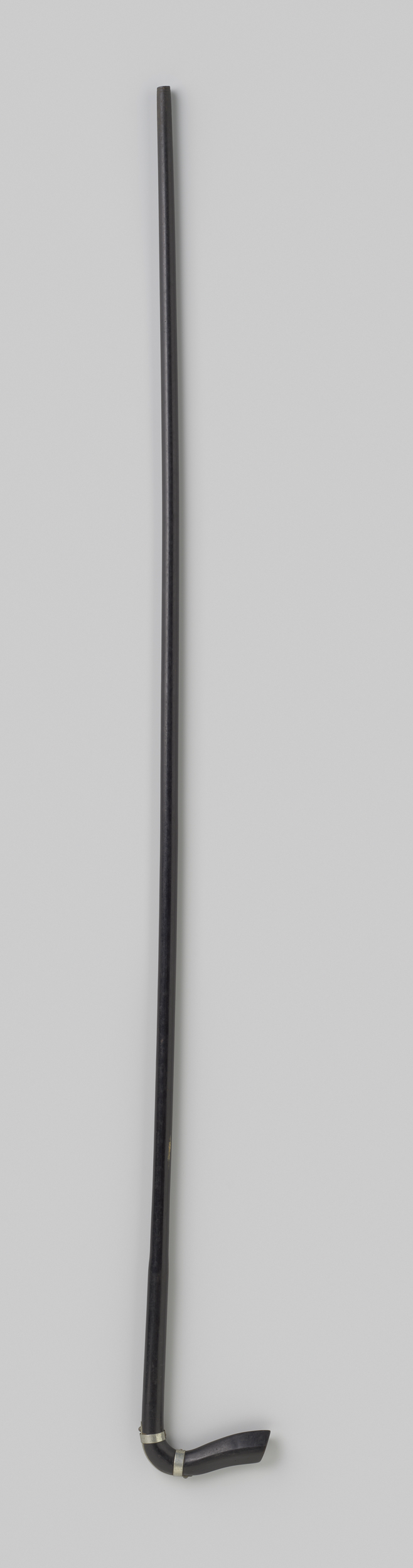 Decorative art piece by Gustav Schnitzler, featuring a black-painted wooden umbrella with silver rings.