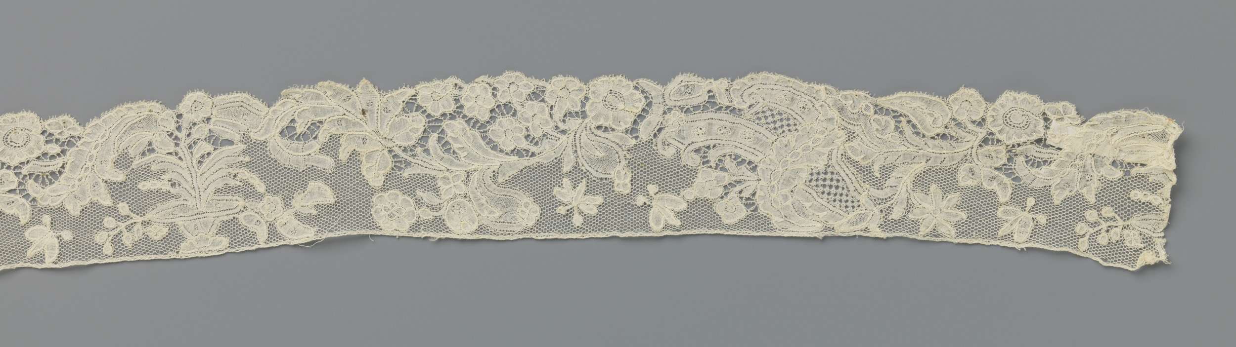 Lace still life featuring a flower and pot by Unknown Artist