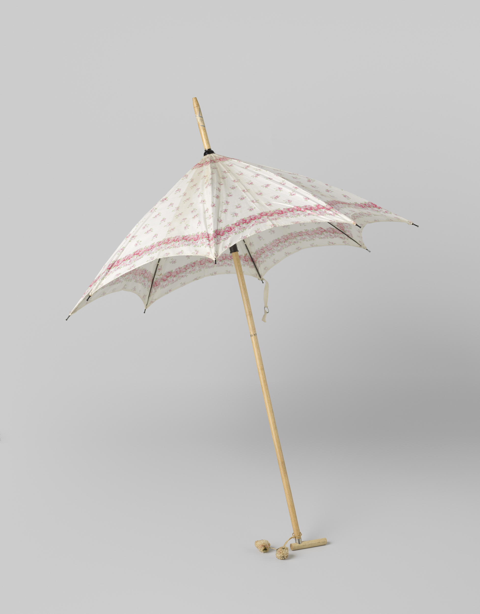Decorative art parasol by Gustav Schnitzler, featuring a white cotton canopy with pink roses.