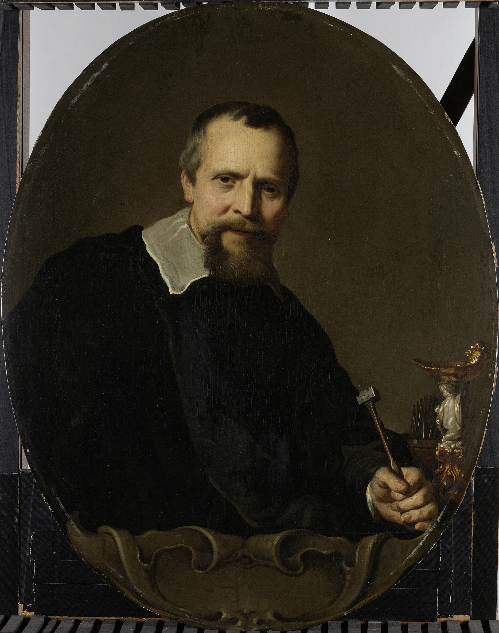 Portrait of Johannes Lutma holding a chasing hammer, oil on panel by Jacob Adriaensz Backer