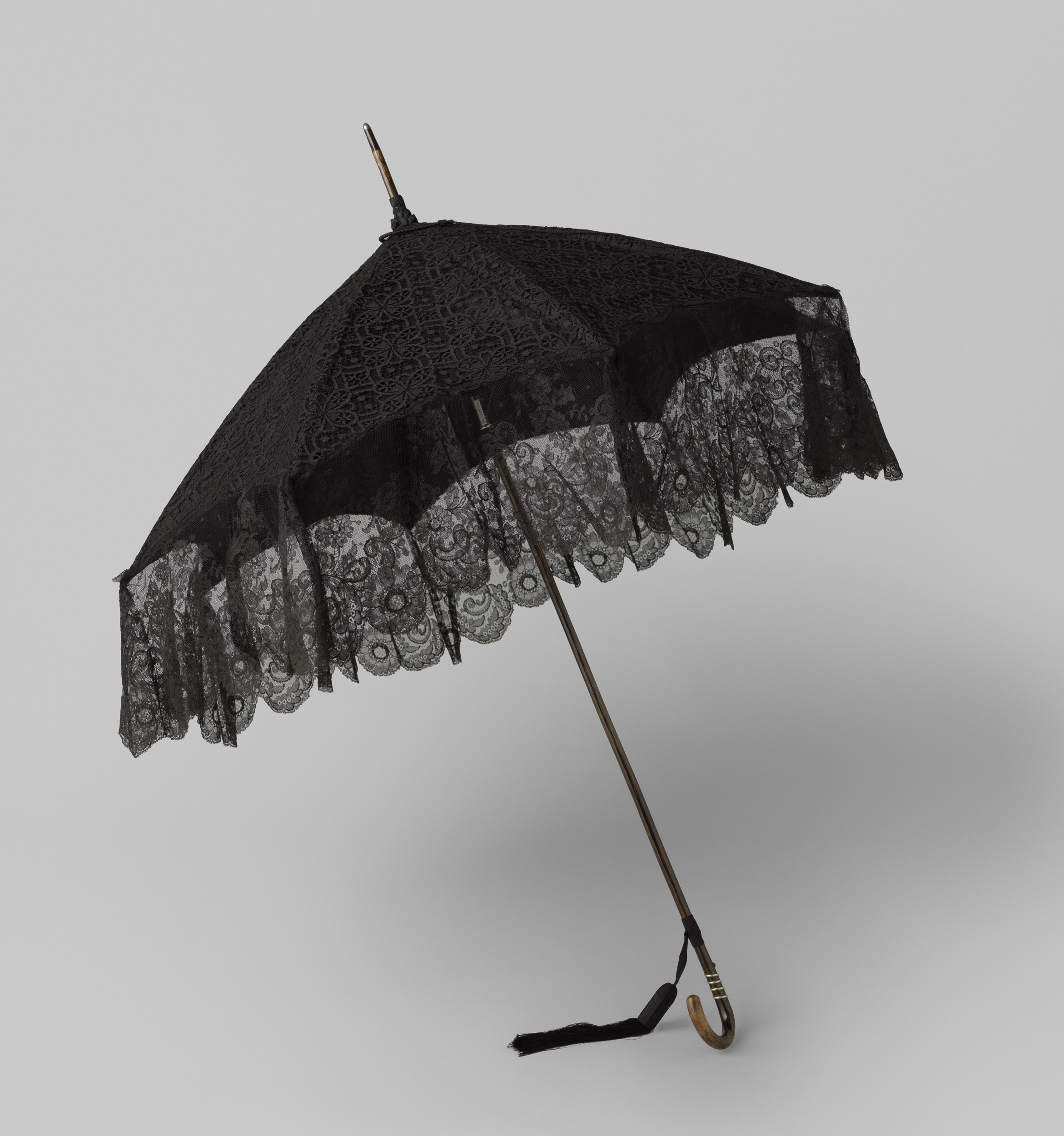 Decorative art featuring a lace parasol by Gustav Schnitzler
