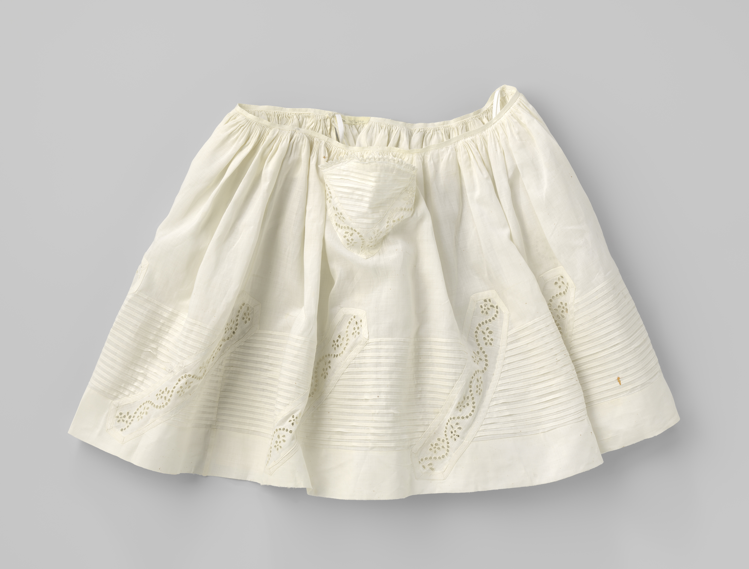 A child's linen dress with intricate embroidery by Unknown Artist