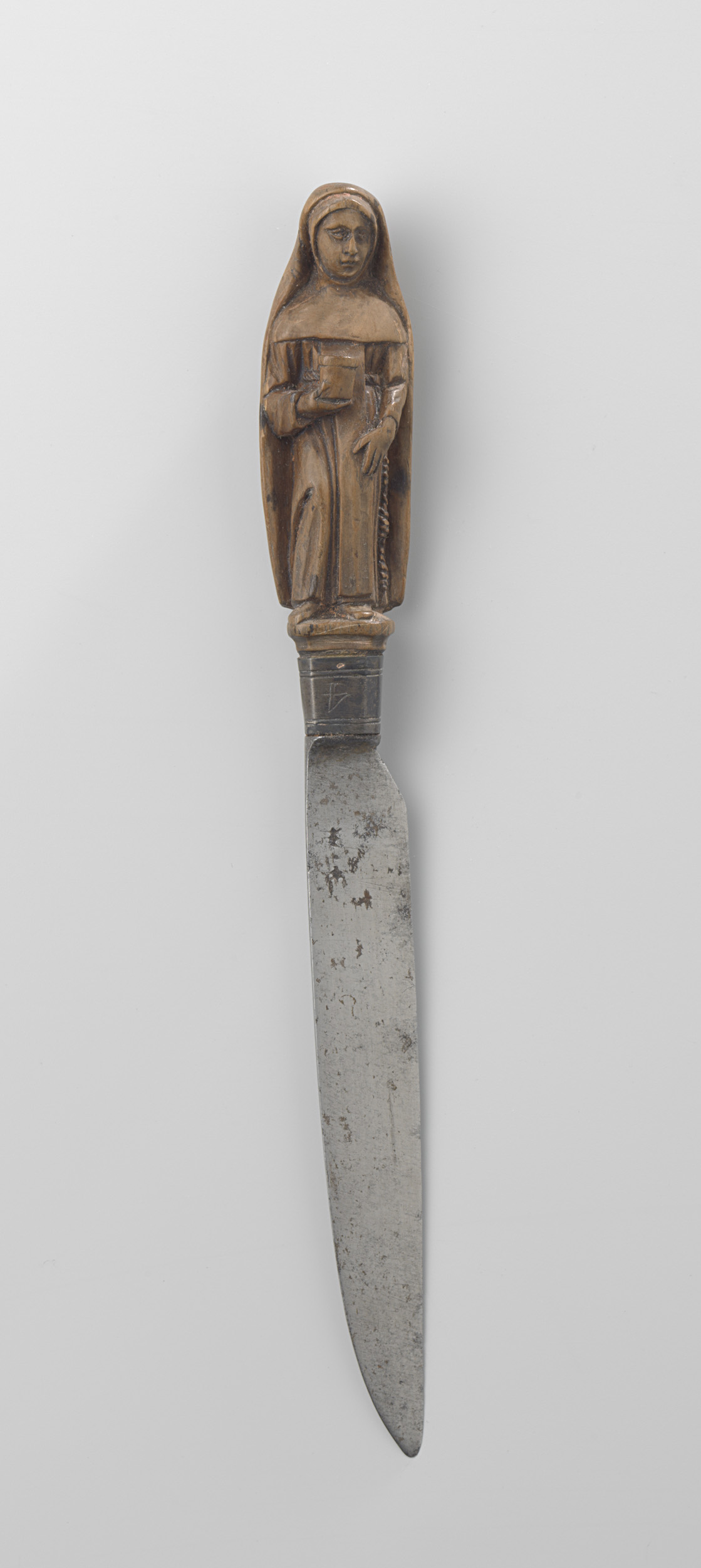 Wood carving of a nun with a flaming heart on a knife, unknown artist