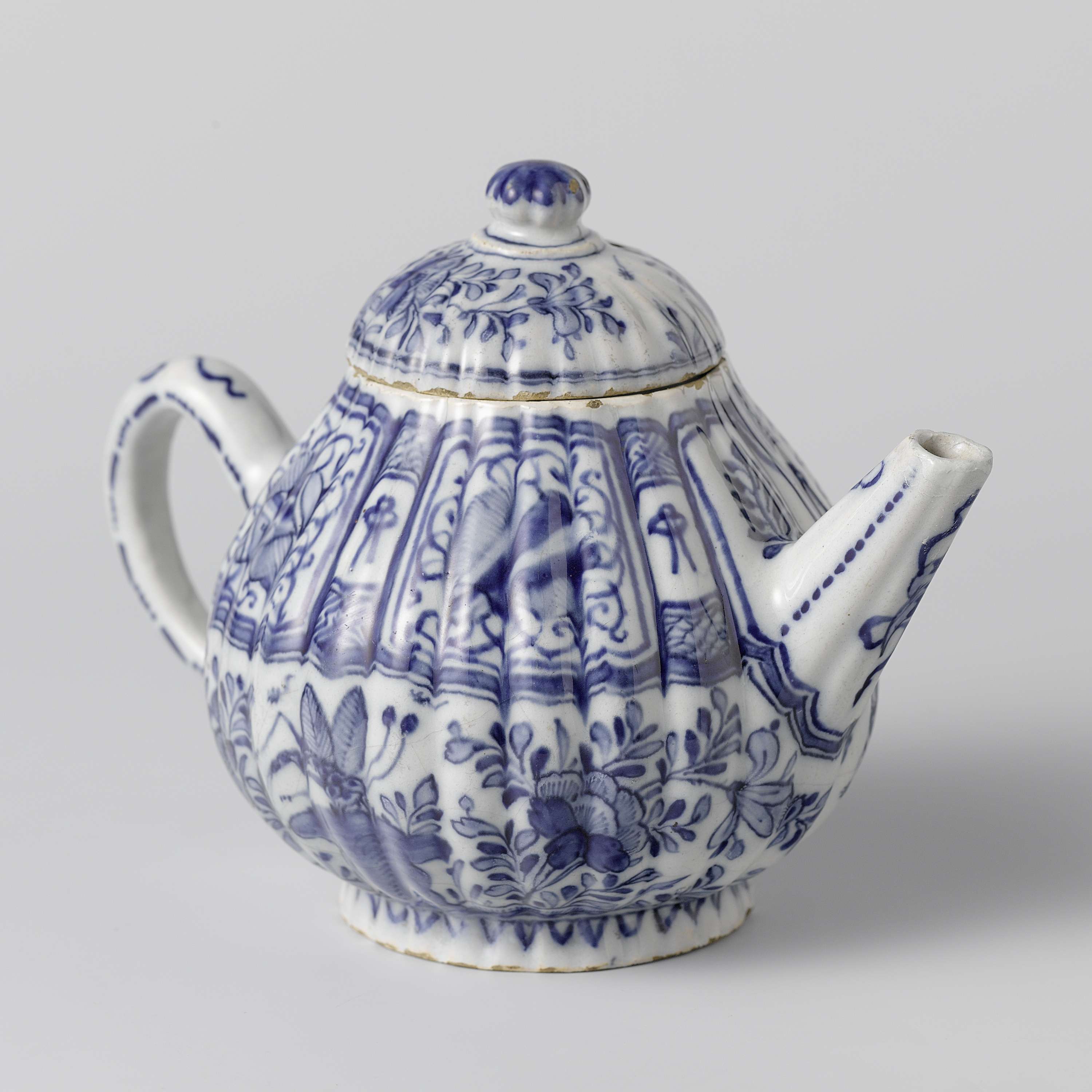 Rococo earthenware teapot by unknown artist, featuring intricate detailing and glaze.